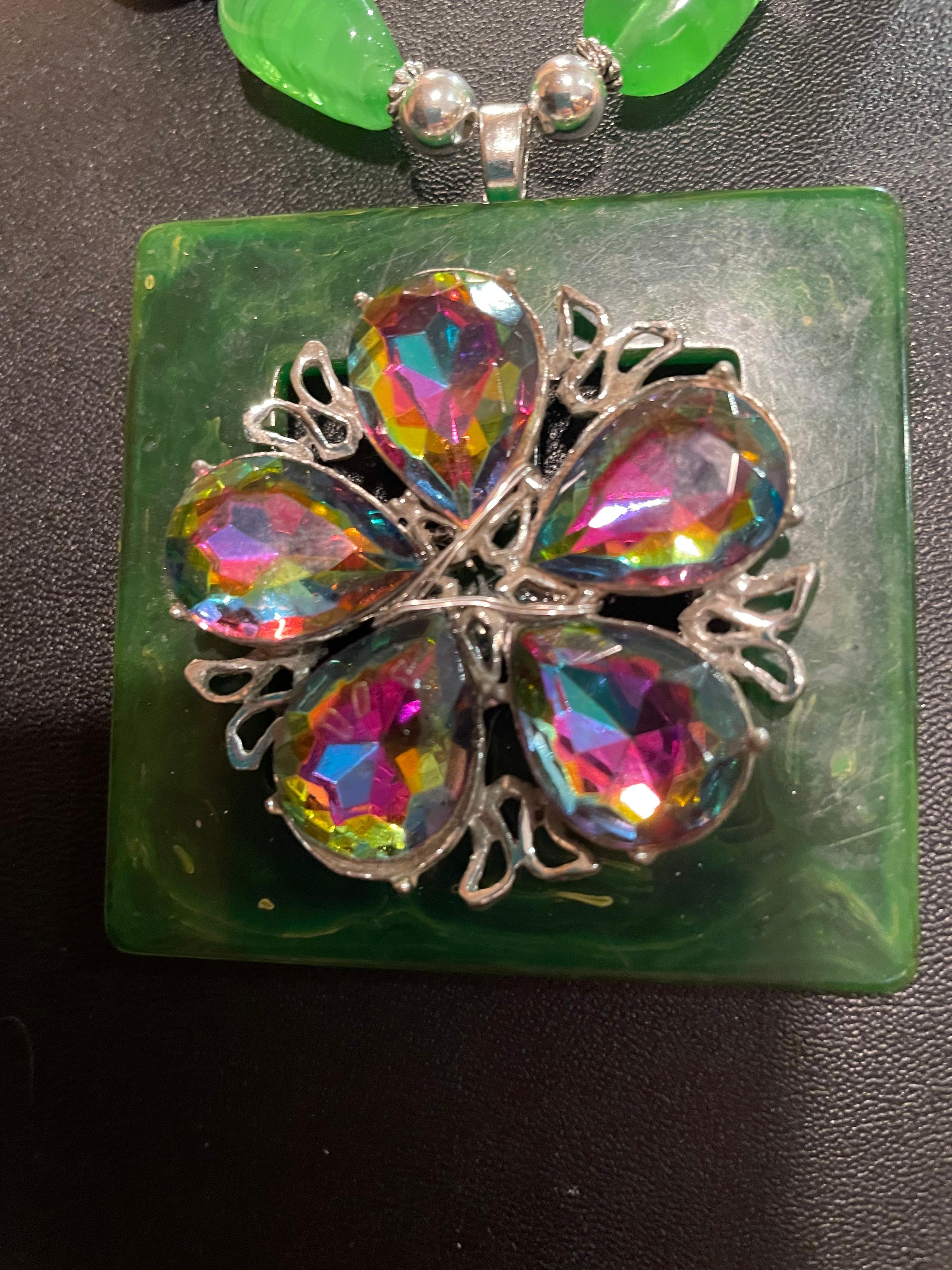 Lorraine’s Bijoux has on offer a Vintage 40’s Green marbelized Square Bakelite belt Buckle pendant with a vintage 60’s AB crystal Brooch. Vintage 1920’s French glass variegated beads and large AB crystal faceted beads, in purple and gold,