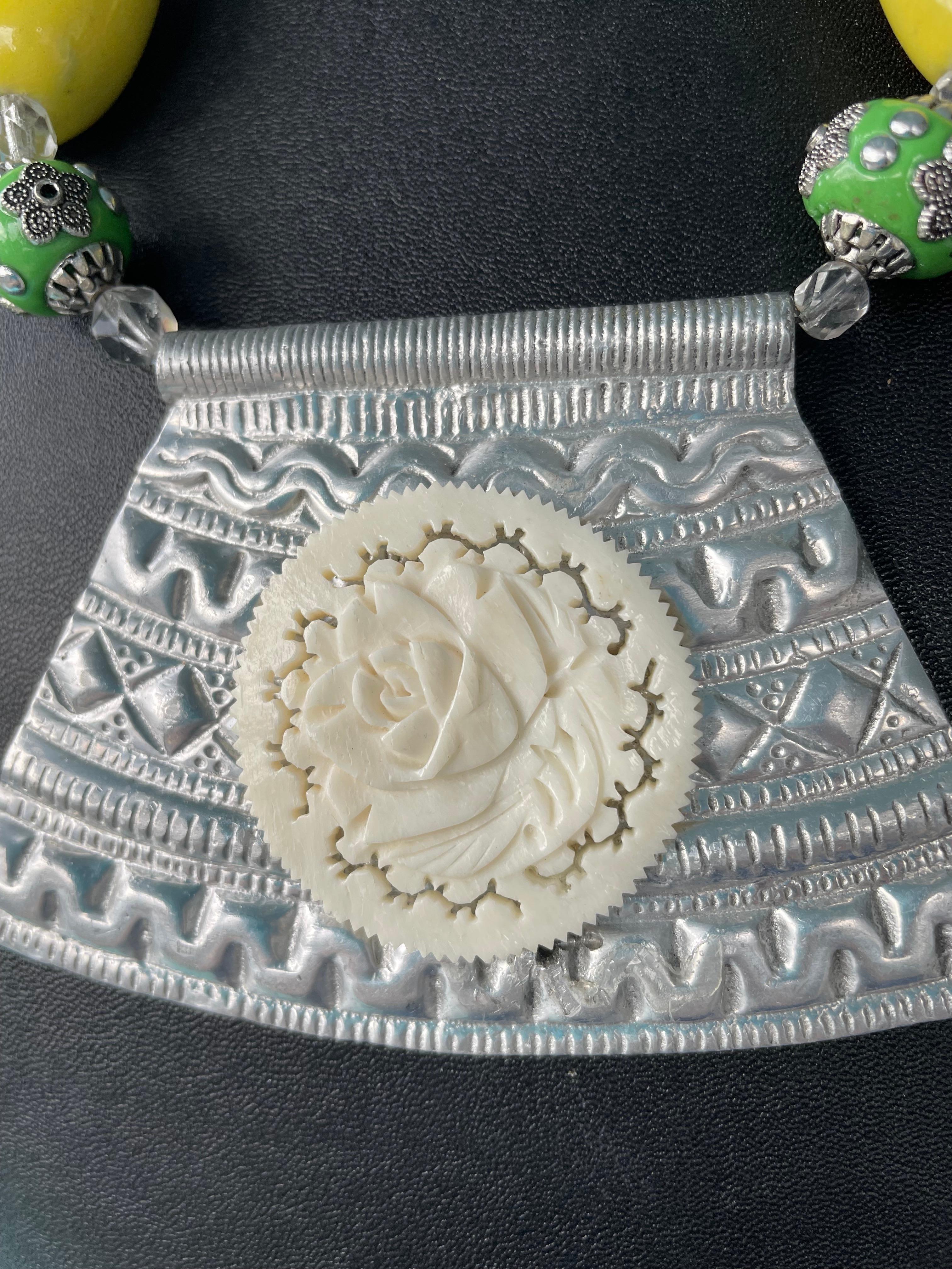 Lorraine’s Bijoux offers a Vintage Indian Metal and vintage carved Bone floral centerpiece necklace with large yellow Resin heart beads, Indonesian green resin and silver beads, Tibetan Silver carved beads, and green and yellow agate beads.
Some