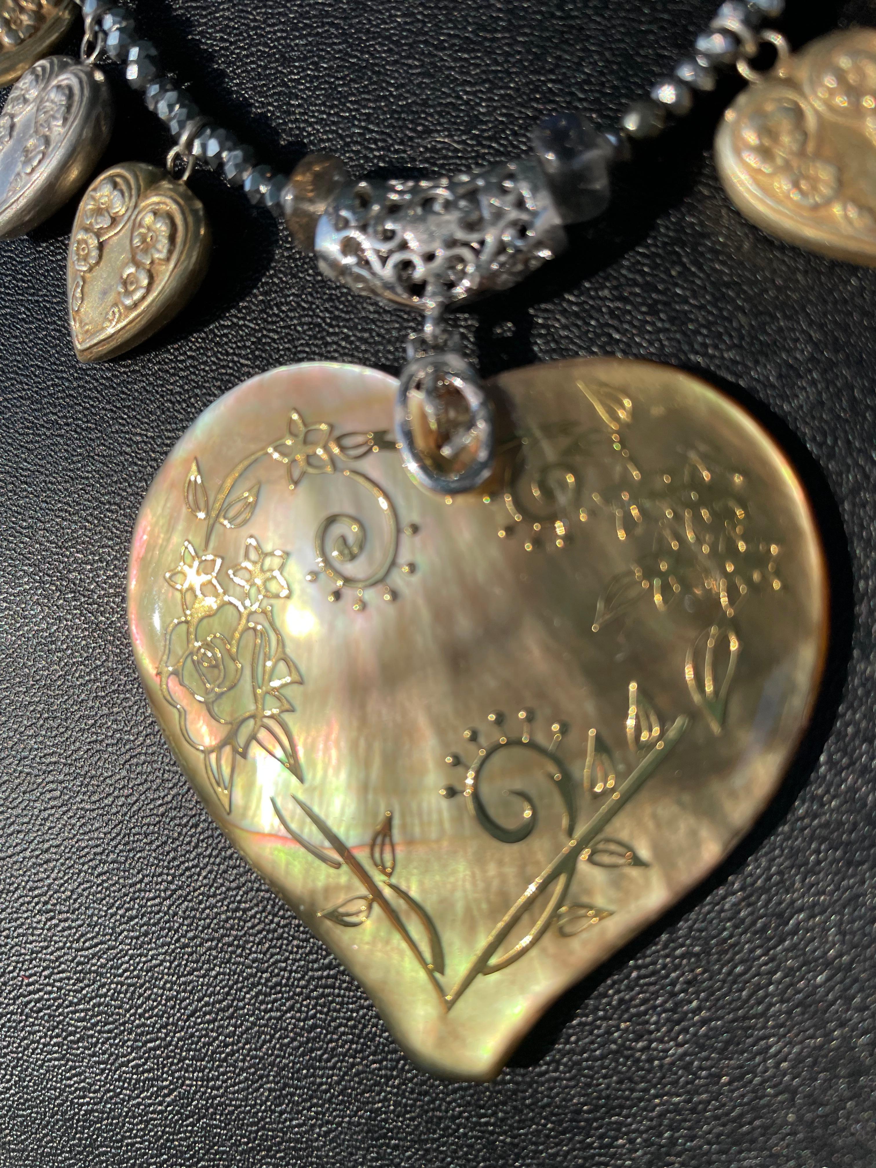 Lorraine’s Bijoux has on offer a Large Carved Shell heart inlaid with gold wire pendant. This large piece is stunning and is suspended from a strand of labradorite rondelle beads, tiny silver beads, Sterling Silver round beads, and lovely vintage