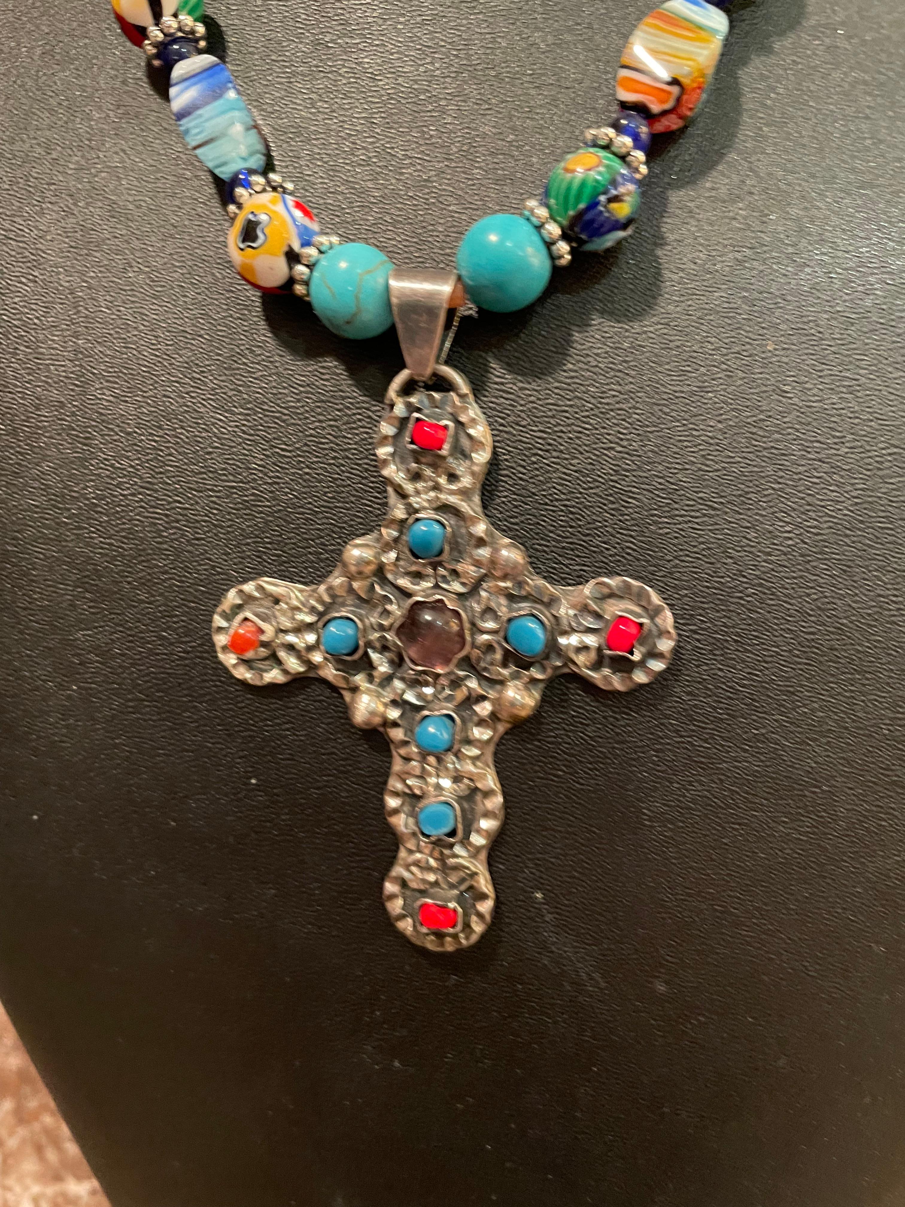 LB offers a one of a kind, handmade, Vintage, Mexican inlaid, Sterling Silver Cross Pendant on a string of vintage handmade Venetian glass beads. This colorful and fantastic piece, with the inclusion of Turquoise rounds and vintage cobalt blue