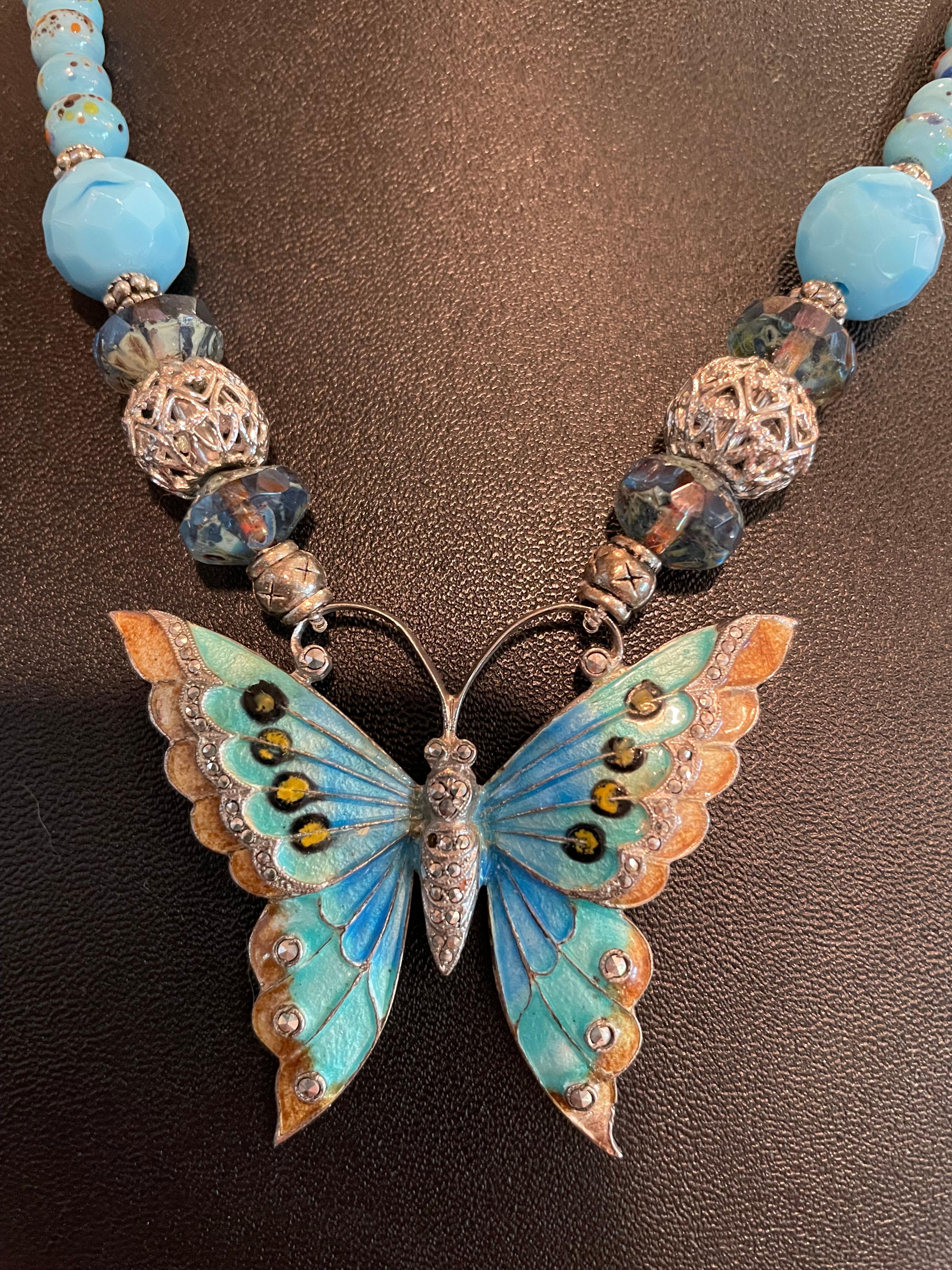Lorraine’s Bijoux offers a Stunning Vintage Sterling Silver and Enamel Pendant necklace. This one of a kind Butterfly centerpiece has inlaid Marcasite stones and multi colored enamel work. The string of gorgeous turquoise colored glass beads