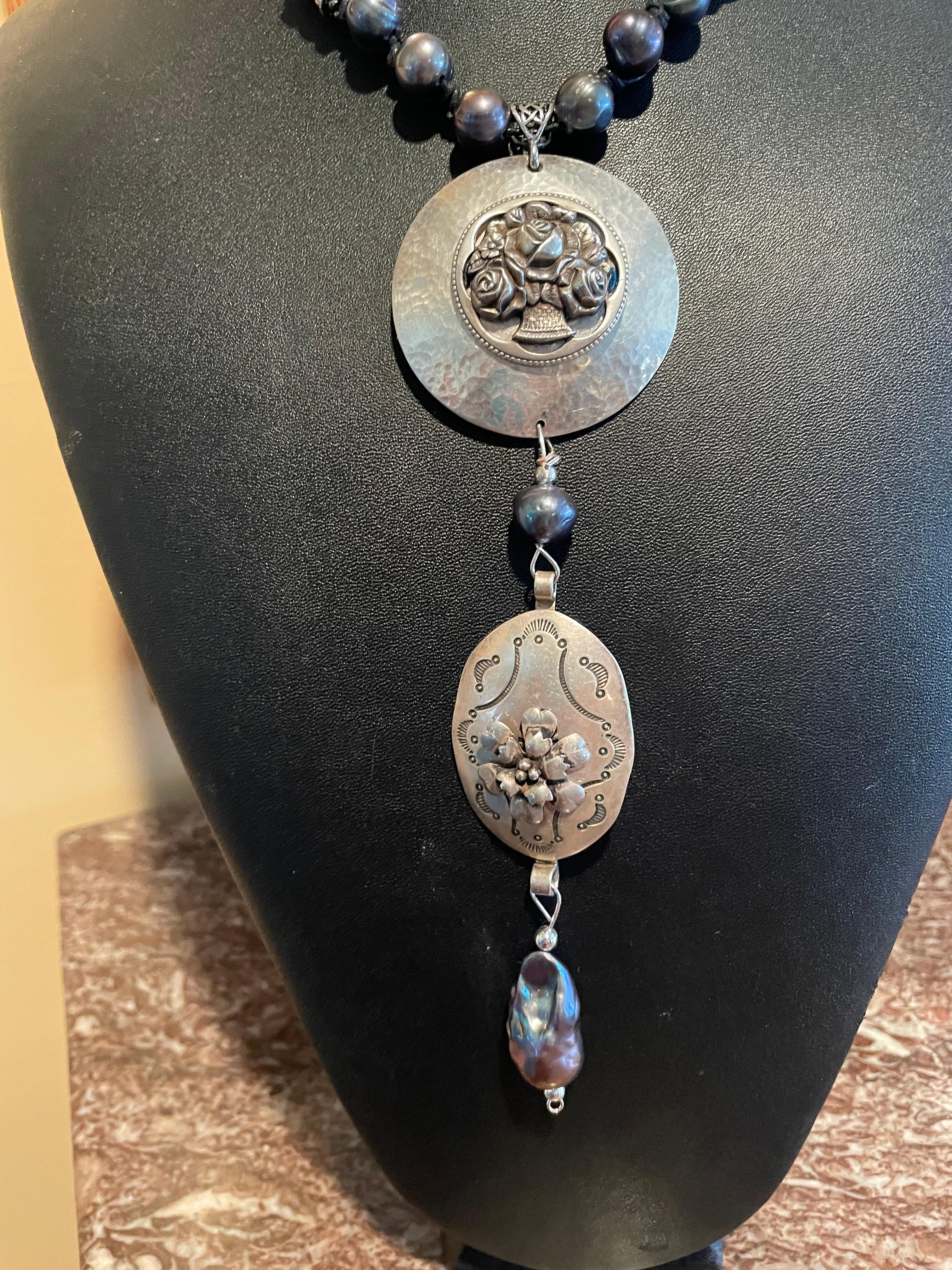 Lorraine’s Bijoux has on offer a necklace with a hanging double Pendant of Vintage Sterling Silver disc ( with floral bouquet sterling brooch ) Large Peacock freshwater Pearls and a vintage Sterling Silver Concho belt piece. A large Peacock pearl