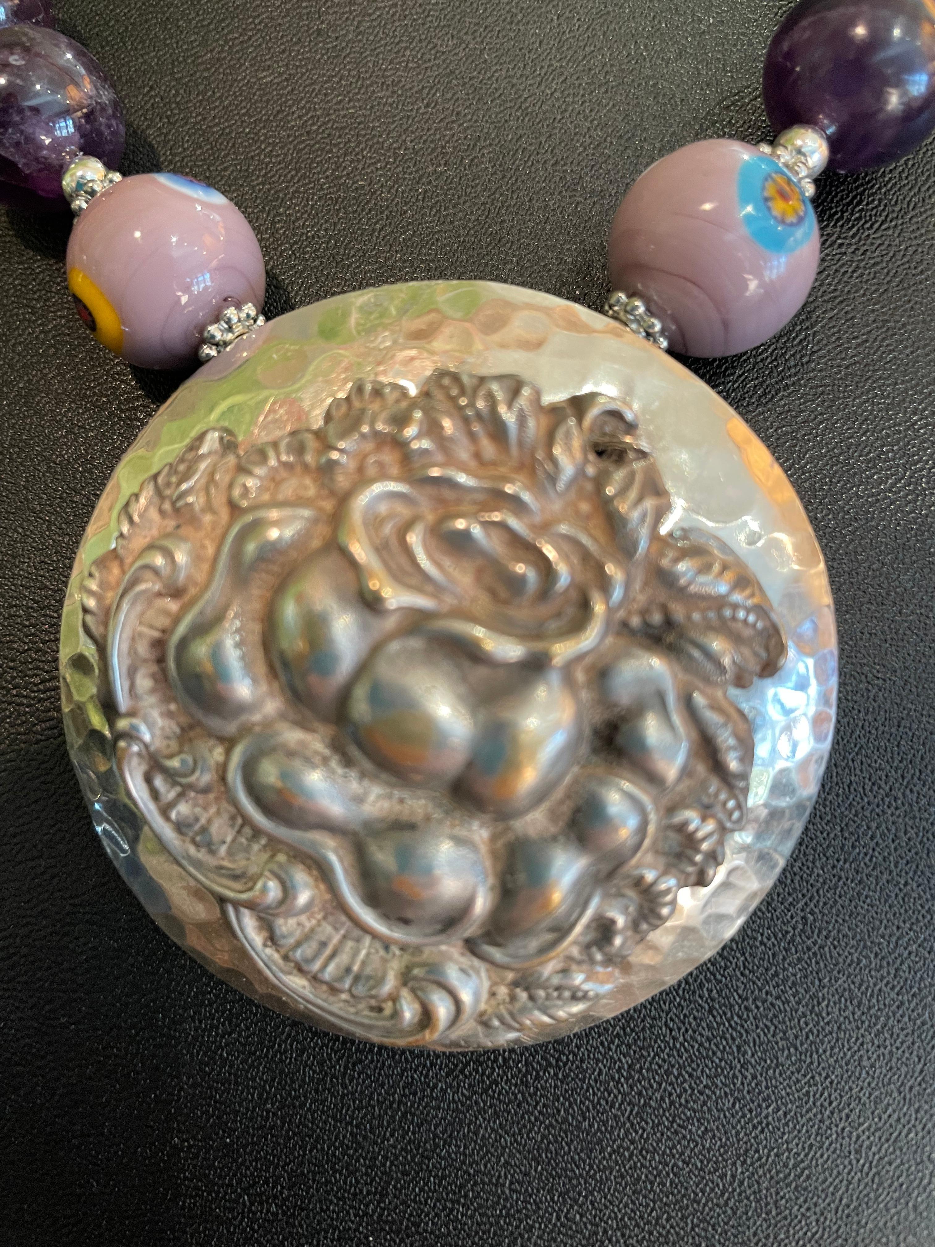 Lorraine’s Bijoux has on offer a Vintage Double Sterling Silver Brooches ( Mexican hammered Sterling and Victorian Sterling floral ) form the pendant. Large Amethyst Round beads, Rose Quartz faceted Rounds, Vintage Venetian Mille Fiore Glass beads,
