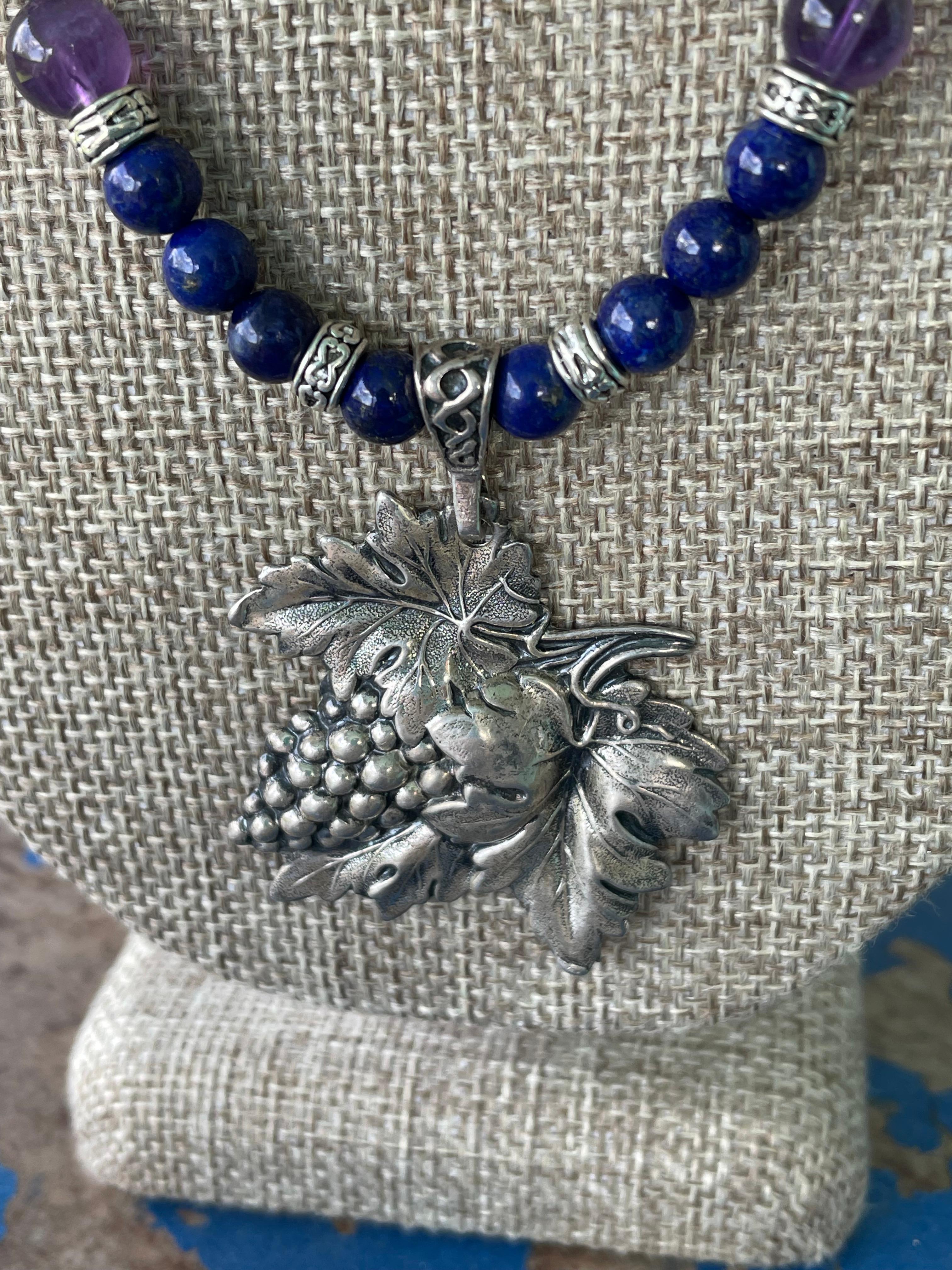 Lorrain's Bijoux propose un collier Vintage, en argent sterling, Repousse, grappe de raisin. Des perles de lapis-lazuli et d'améthyste et de l'argent sterling rehaussent cette broche/pièce maîtresse inhabituelle. Des perles incurvées en argent