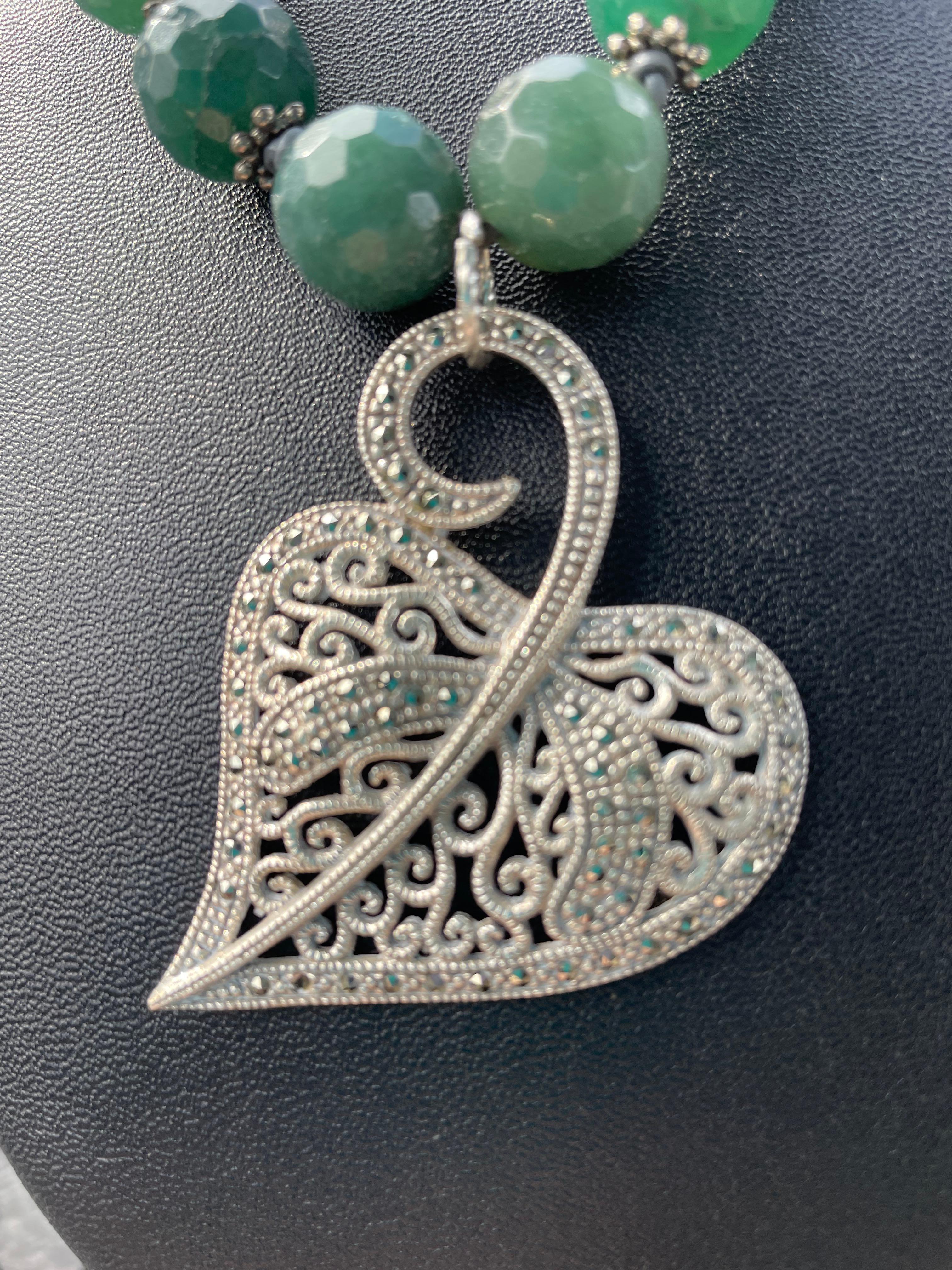 Lorraine’s Bijoux offers a Vintage Sterling Silver and Marcasite Leaf Brooch pendant with vintage glass rose bud and leaf sections, green faceted crystals, vintage AB crystals, crystal inlaid black beads, on a hand braided cotton cord. This piece is