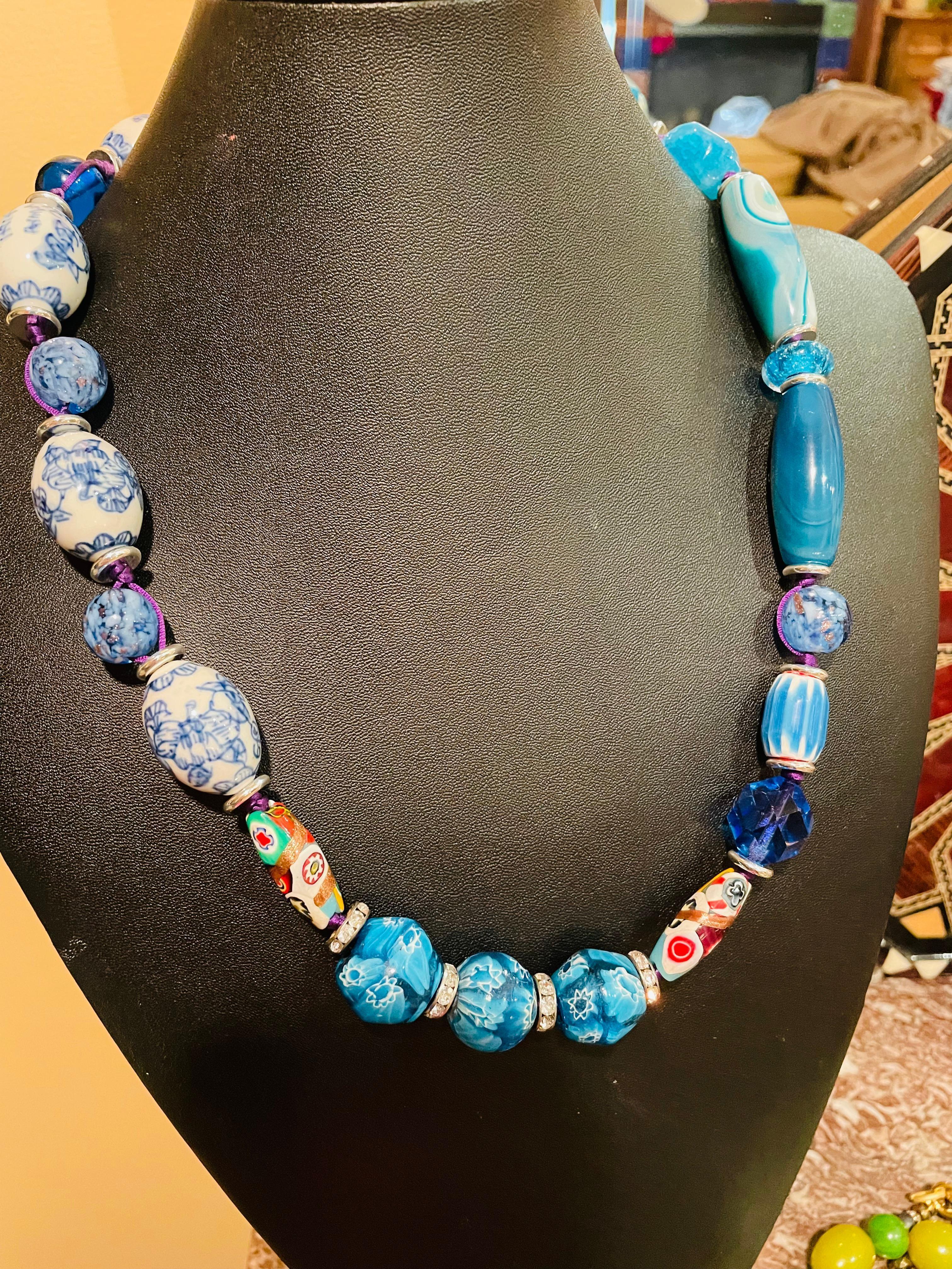 Lorraine’s Bijoux has on offer a Blue beaded necklace with Tubular Blue Agates, Blue and White Ceramic beads, vintage crystal and Glass, Vintage Mille Fiore glass beads, Sterling Silver Rondelles, Crystal Rondelles, This is the perfect piece to wear