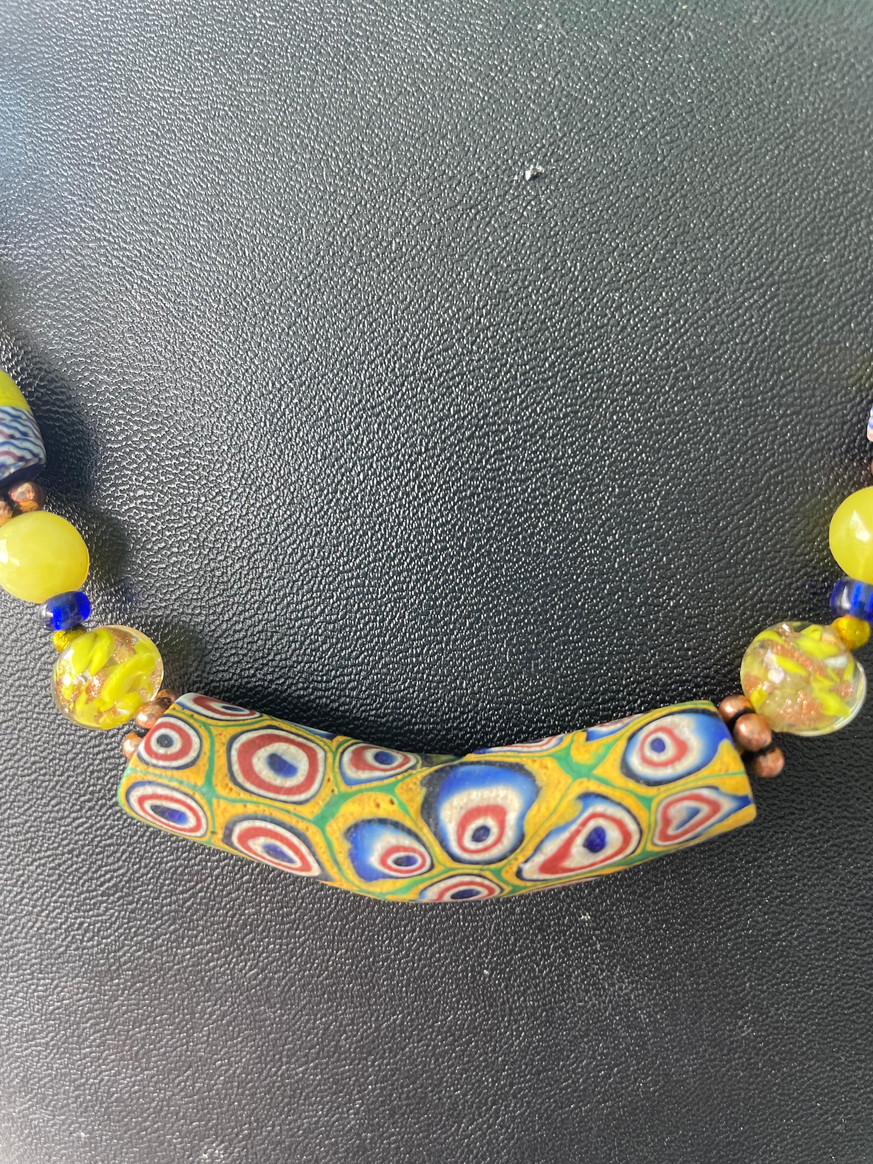 Lorraine’s Bijoux has on offer a Vintage Venetian glass Trade beads with a central glass elbow shaped bead. These beads were made to trade to other countries in exchange for goods and services.Each bead is different from the others and irregular in