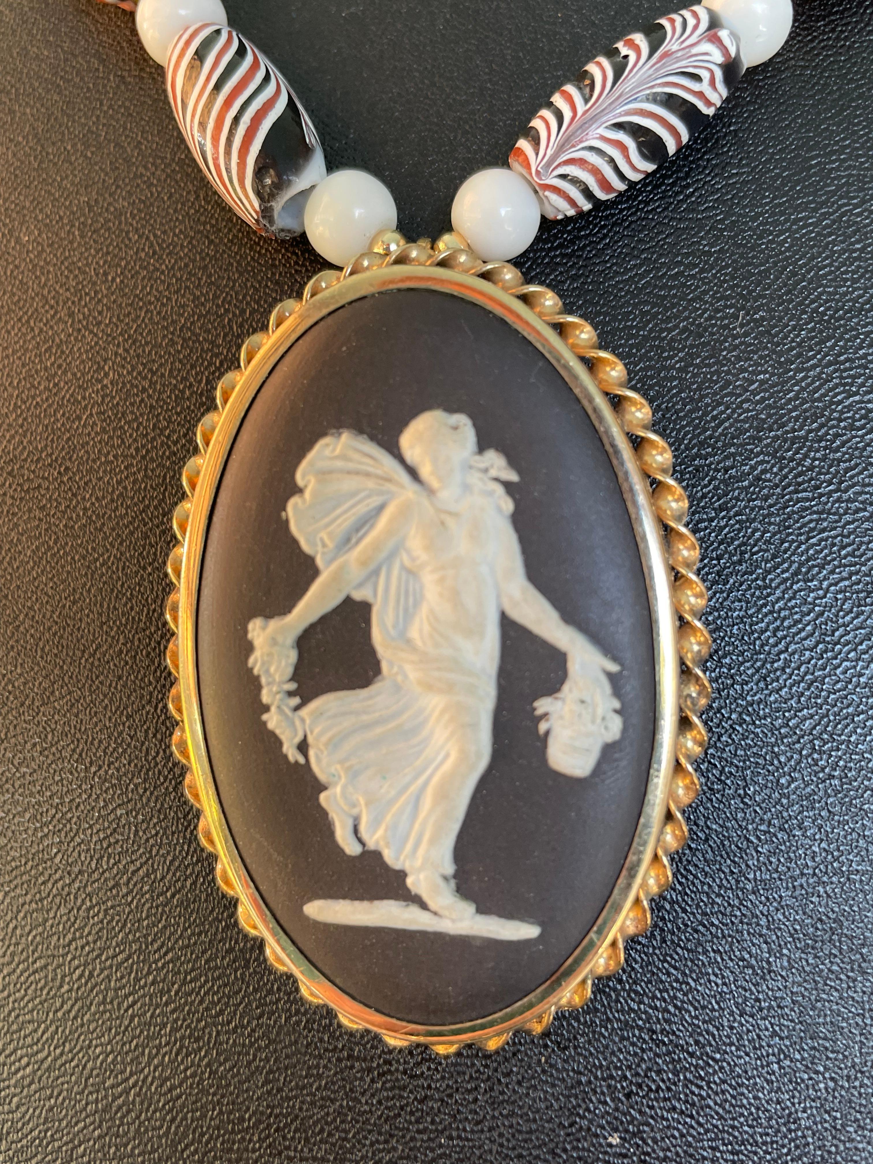 Lorraine’s Bijoux has on offer a Vintage, Wedgewood, Jasperware, black and white oval pendant necklace. The fabulous beads are vintage Venetian glass African trade beads in naturals and reds. Vintage white glass spacers and African brown and white