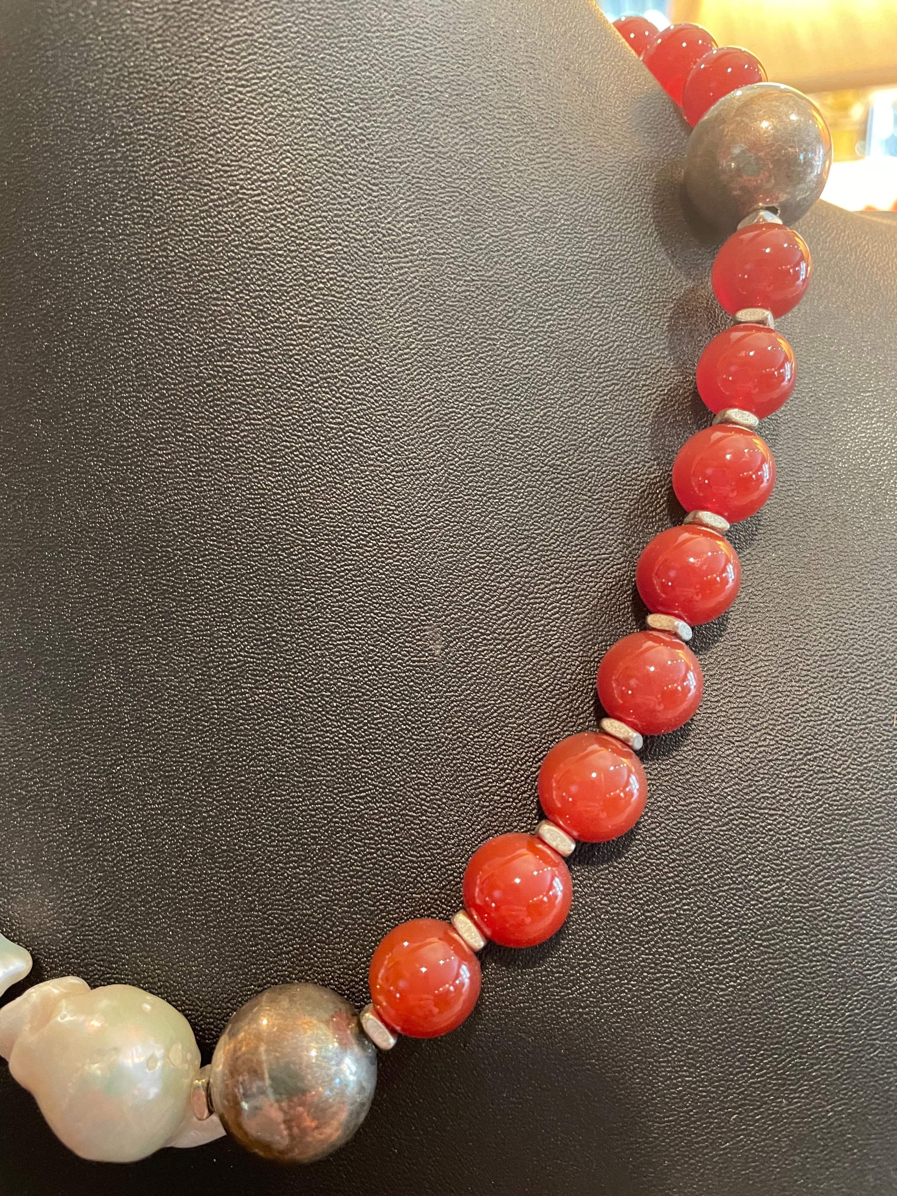 LB  offers large round Carnelian  beads and Large Chinese Baroque Pearls and Sterling Silver, handmade,one of a kind necklace.Large sterling silver Vintage Mexican beads are a great counterpoint to the pearls and the wonderful orange carnelian.