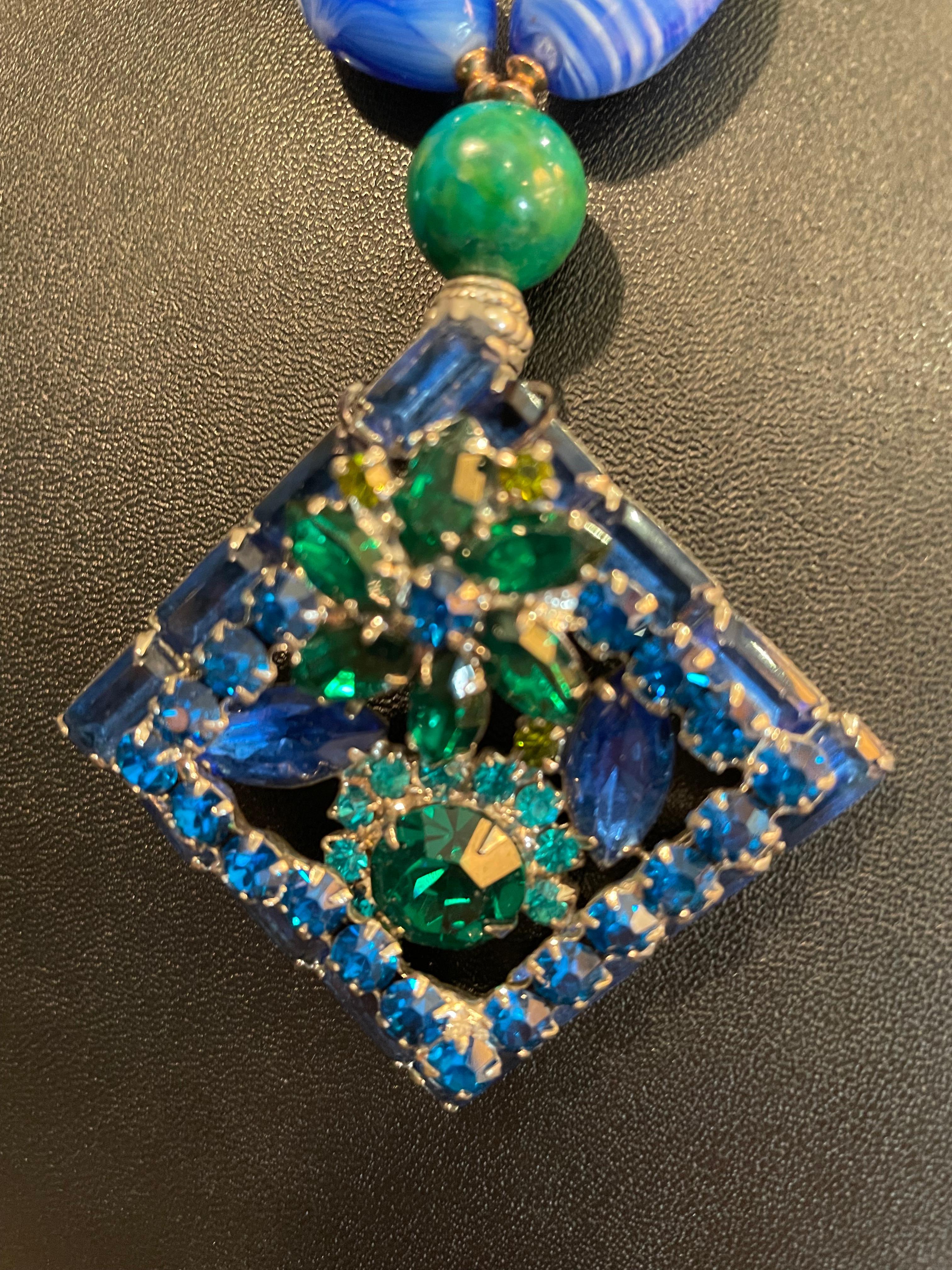 Lorraine’s Bijoux offers a Retro style 60’s Brooch pendant, handmade, one of a kind, necklace. A string of fabulous vintage French 20’s blue glass beads, genuine turquoise beads, vintage blue crystals, green glass Mille Fiore Venetian vintage beads,