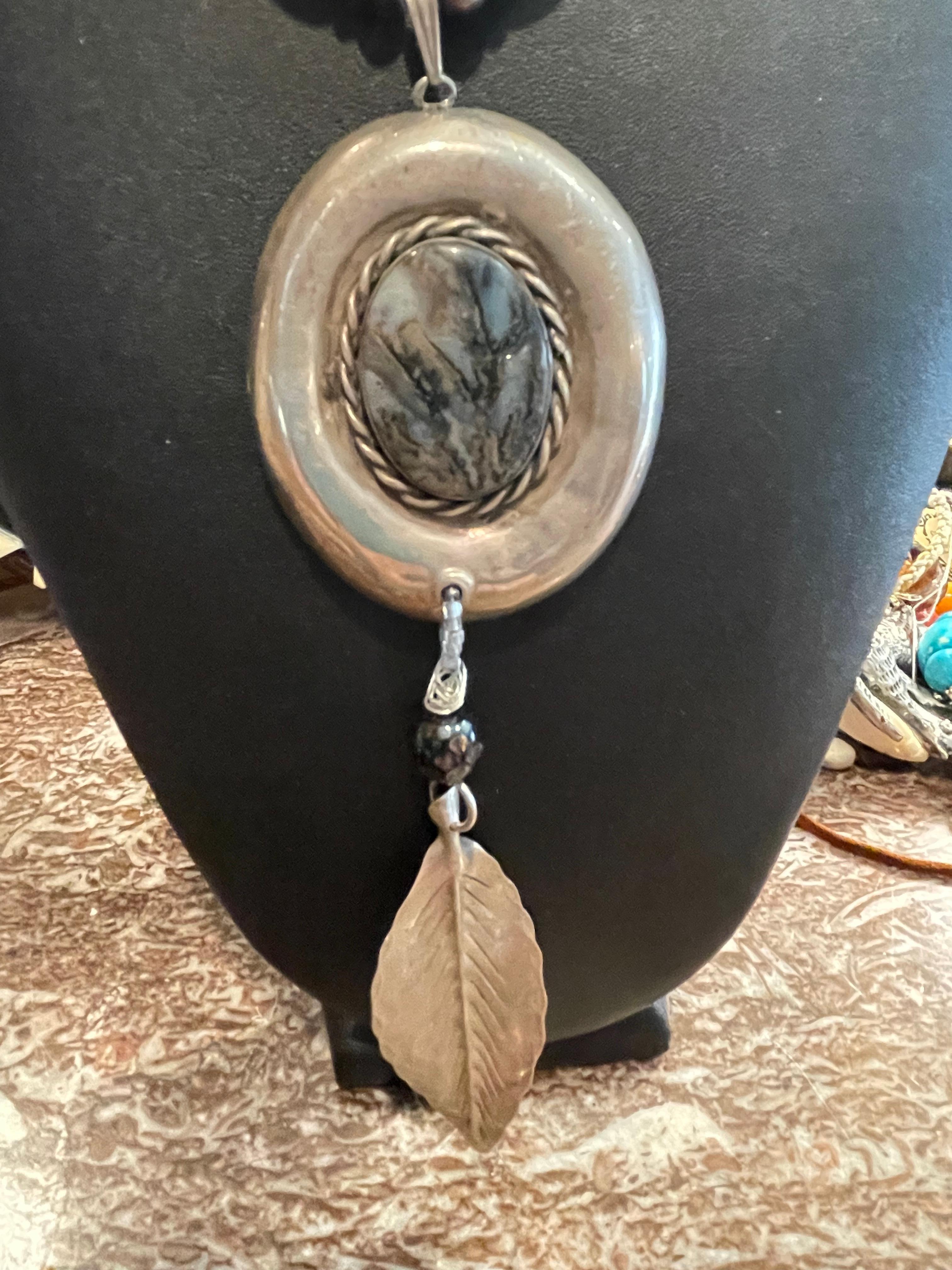 LB Vintage Sterling Silver and Charorite pendant with vintage sterling silver leaf brooch accent with Amethyst beads emphasizing the coolness of the Sterling beads. This handmade, one of a kind, piece would be a glamorous and versatile addition to