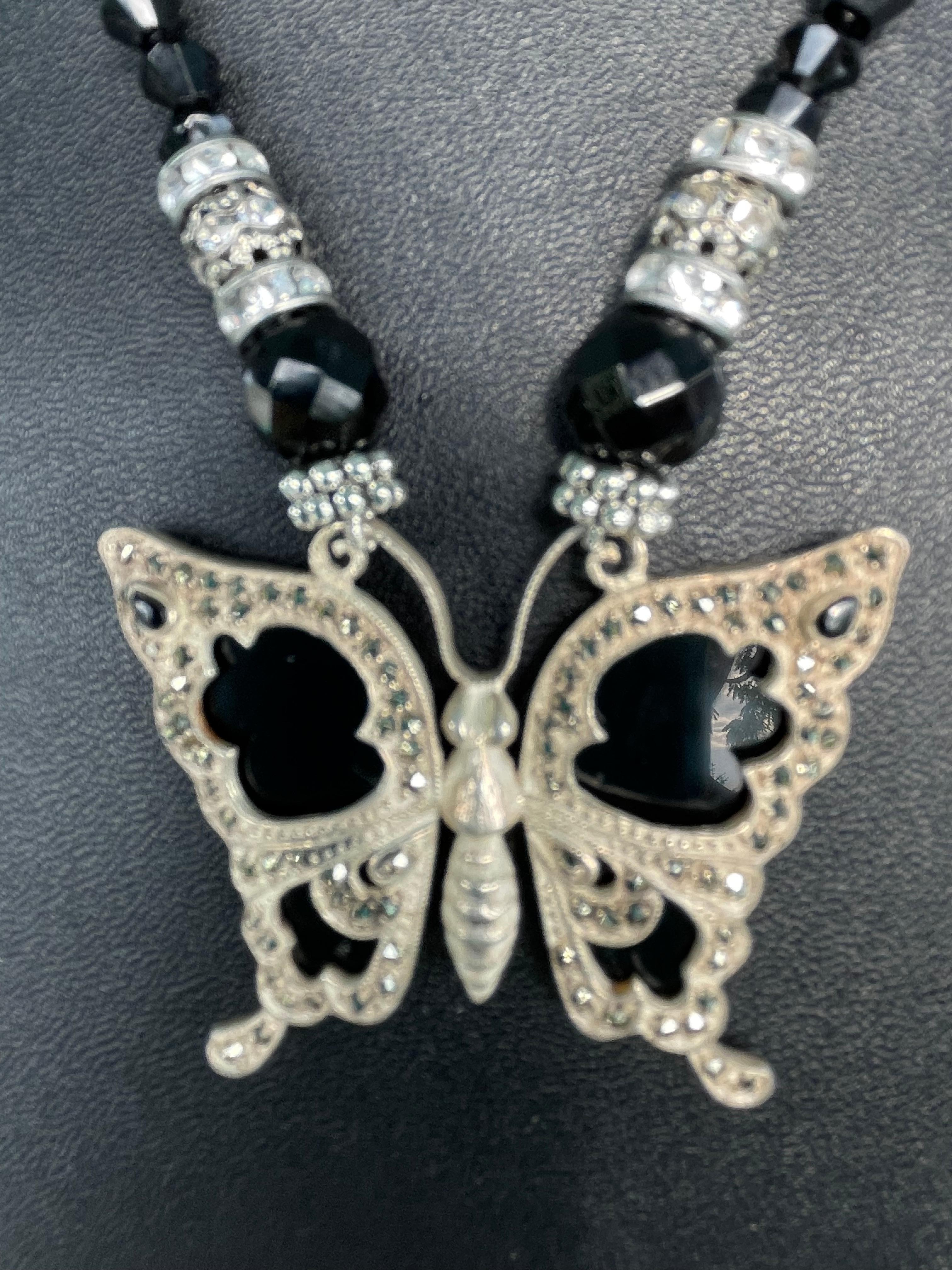 Lorraine’s Bijoux offers an antique Sterling Silver, onyx, ,and marcasite butterfly pendant necklace.
This is a one of a kind , handmade piece with onyx beads, crystal rondelles, and crystal inlaid cage beads comprising the string of beads. 
A large