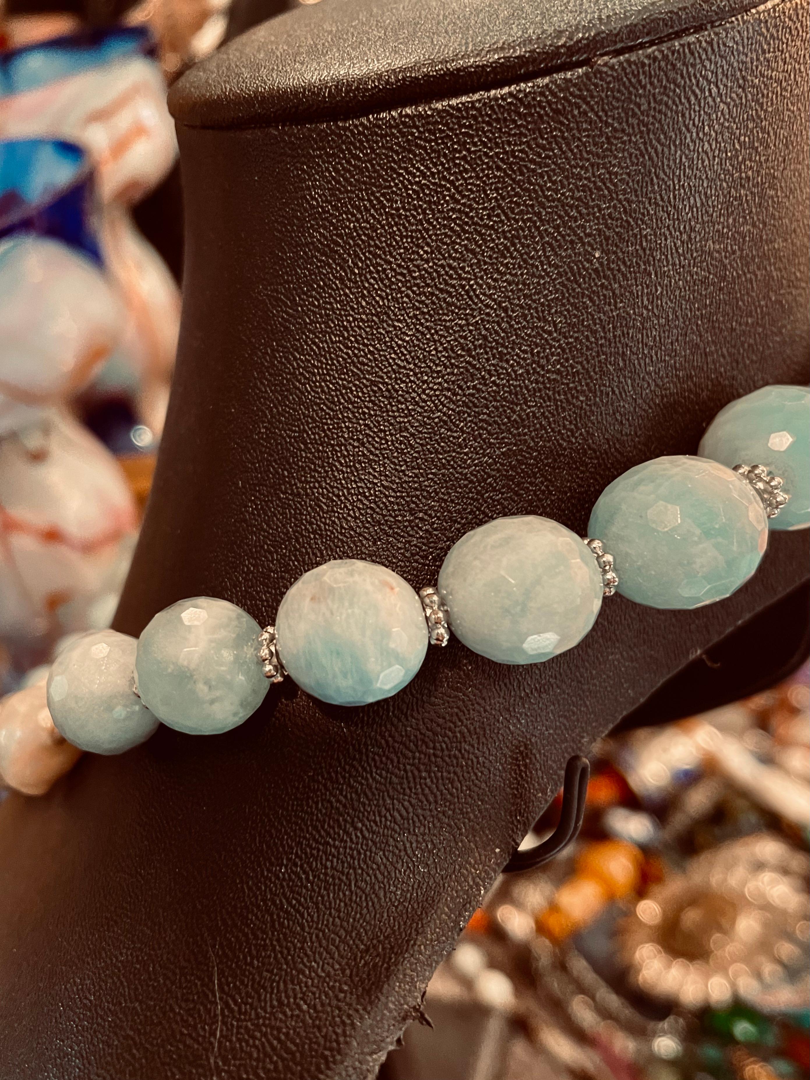 Lorraine’s Bijoux offers a Stunning necklace with Large Blue Aquamarine faceted beads, luscious large White  Baroque Freshwater Pearls, faceted pyrite spacer beads, Sterling Silver vintage Mexican beads. This is a very gorgeous necklace that will