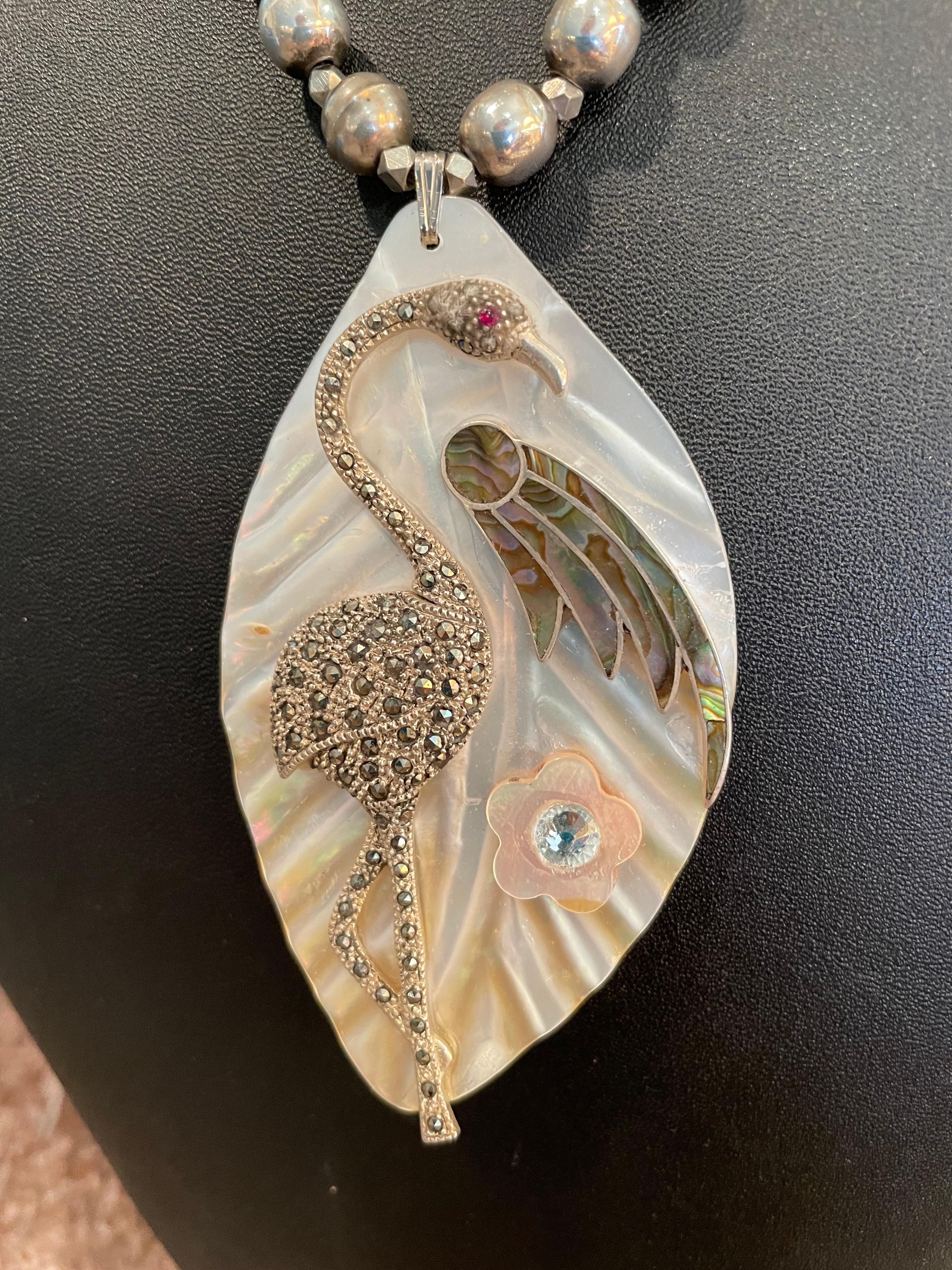 A Stunning Large Mother of Pearl carved Pendant with Vintage Sterling Silver and Marcasite Flamingo Brooch is on offer from Lorraine’s Bijoux. A beautiful vintage Paua shell earring and flower add interest to this fabulous piece. A string of