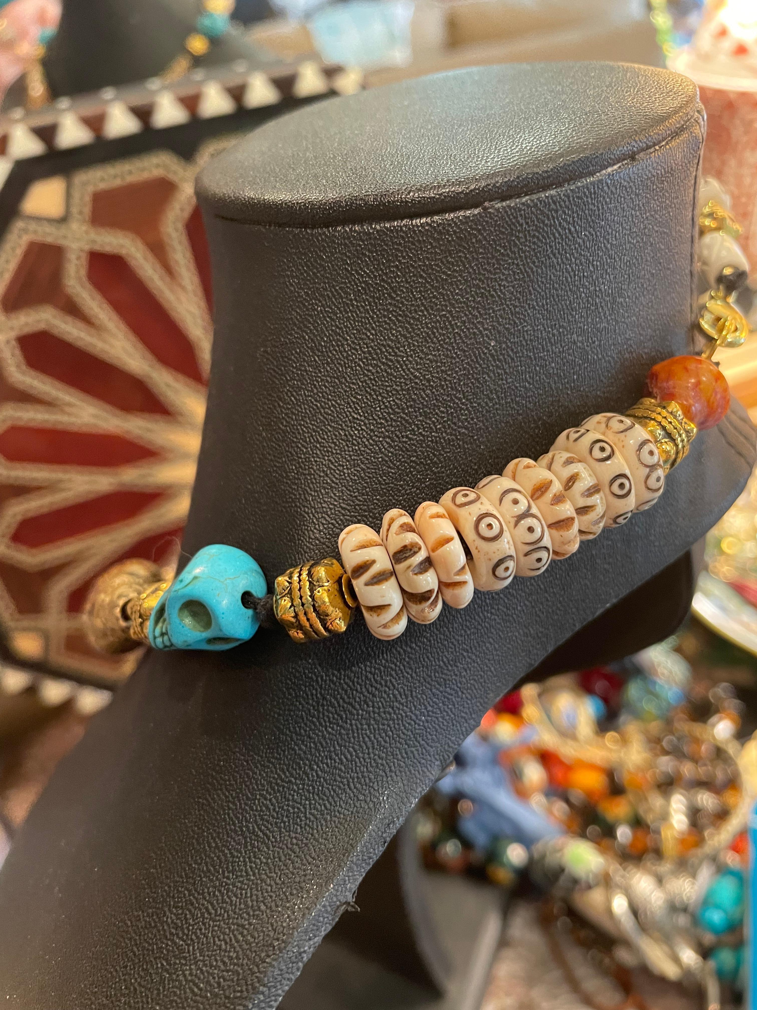 Large Tibetan brass and Amber handmade pendant with turquoise stone skull beads,antique Indian agate and brass 
Beads, and bone discs comprise this handmade, one of a kind, necklace.This stunning and dramatic piece will definitely make you stand out