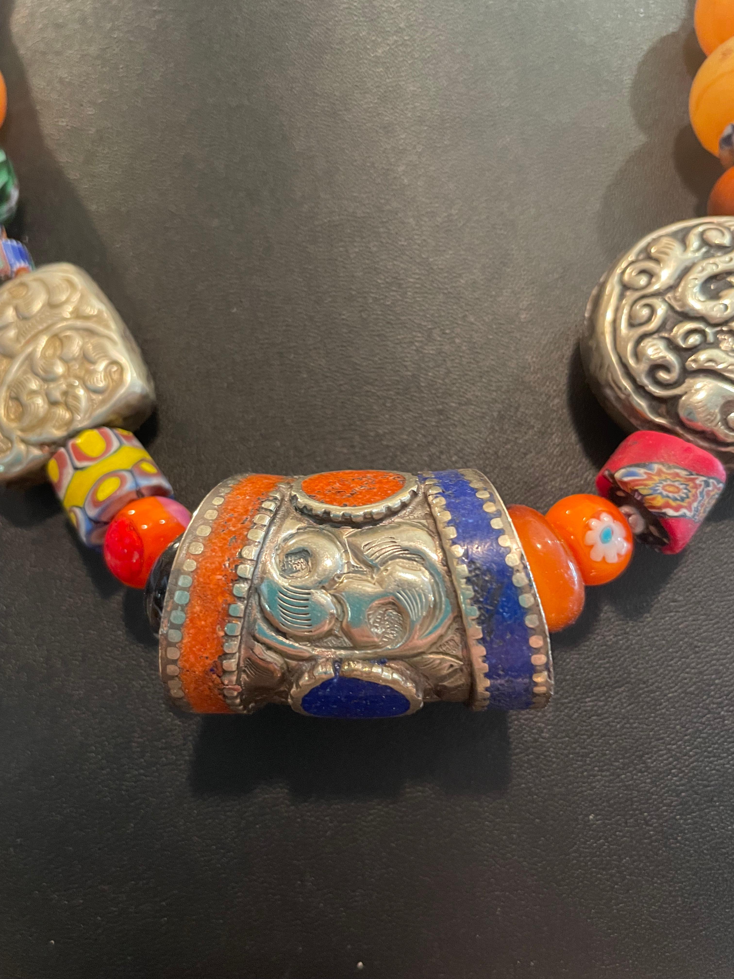 LB offers a Tribal style necklace of Tibetan silver, Afghani inlaid centerpiece, Vintage Venetian glass trade beads,coral,copal amber, Sterling Silver vintage Mexican beads.
The end cones are Silver from Thailand. This is a chunky piece that will
