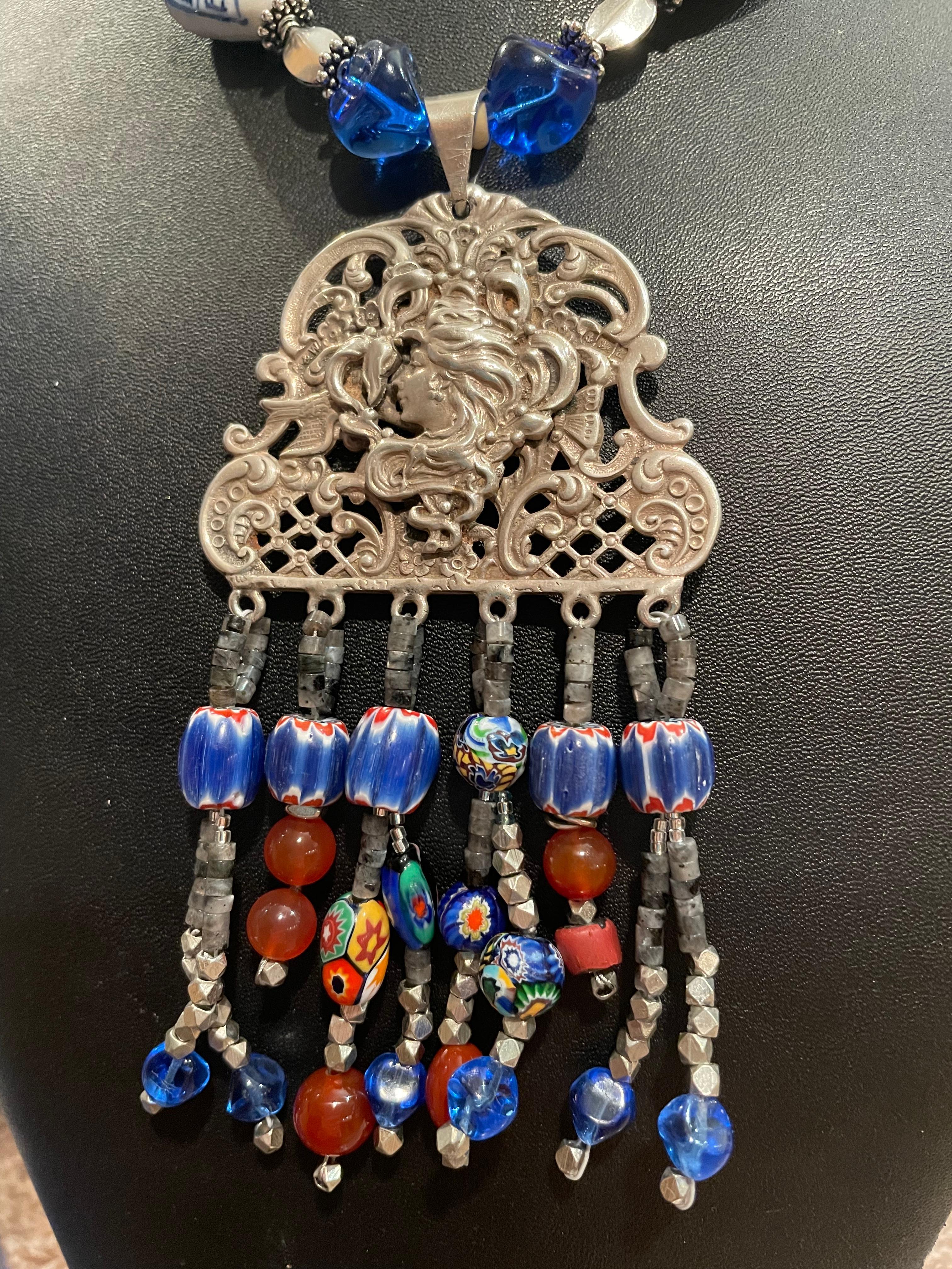 Lorraine’s Bijoux presents a tribal style necklace with antique Art Nouveau sterling pendant.A string of Carnelan, Chinese ceramic, and sterling beads enhance  this fabulous piece. Cobalt blue glass beads from Paris( a quaint little shop)are a