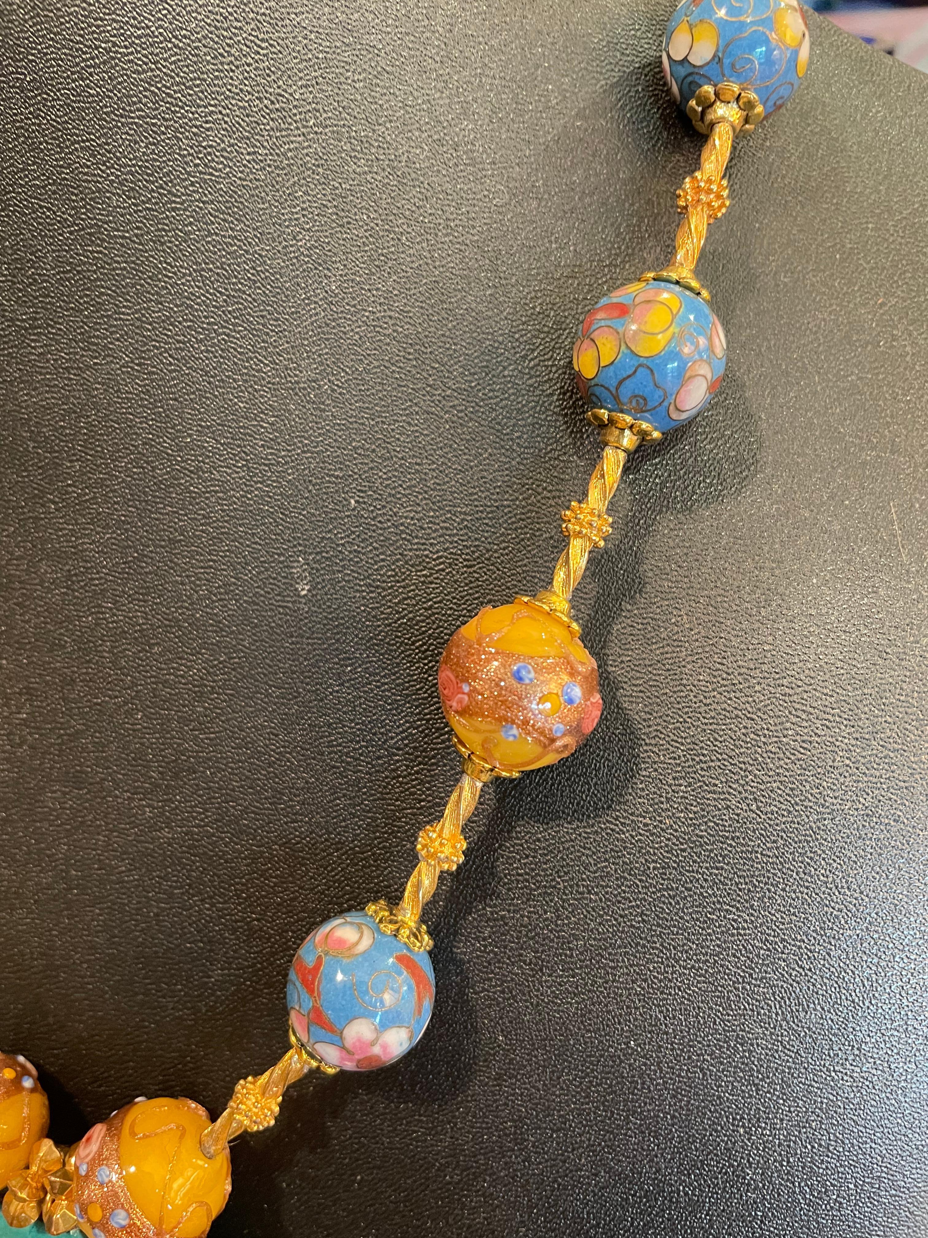 Lorraine’s Bijoux offers a vintage, multicolored , cloisonné heart necklace accompanied by Vintage,Venetian glass Wedding cake handmade beads. This heart was found in an antique shop in Western Michigan and was struck by its’ beauty and