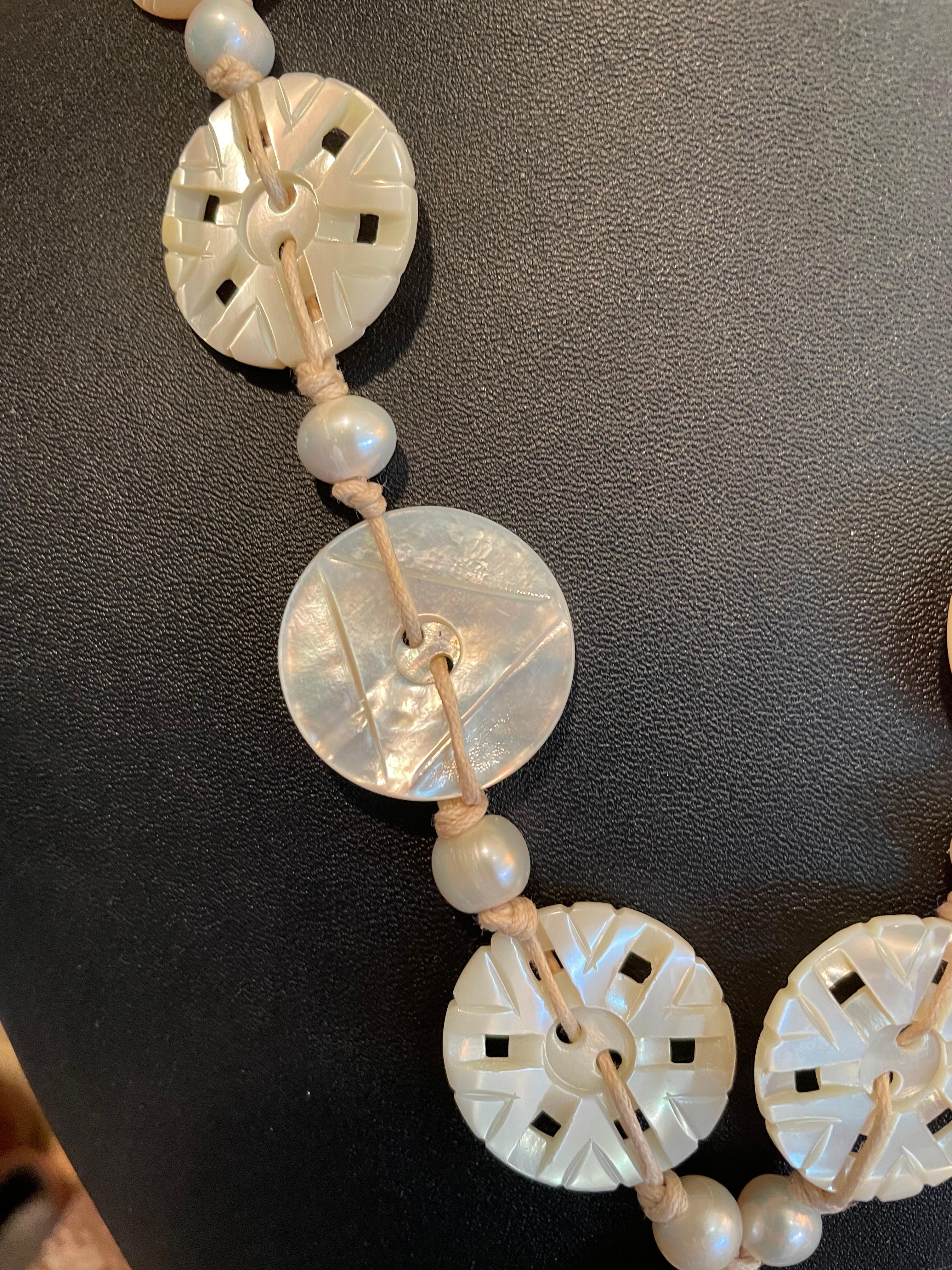 Lorraine’s Bijoux offers a Stunning, Handmade, One of a Kind, Vintage Mother of Pearl Button Necklace. These gorgeous, hand carved, genuine Mother of Pearl buttons comprise this unusual handcrafted piece. These buttons date from the 30’s-40’s and
