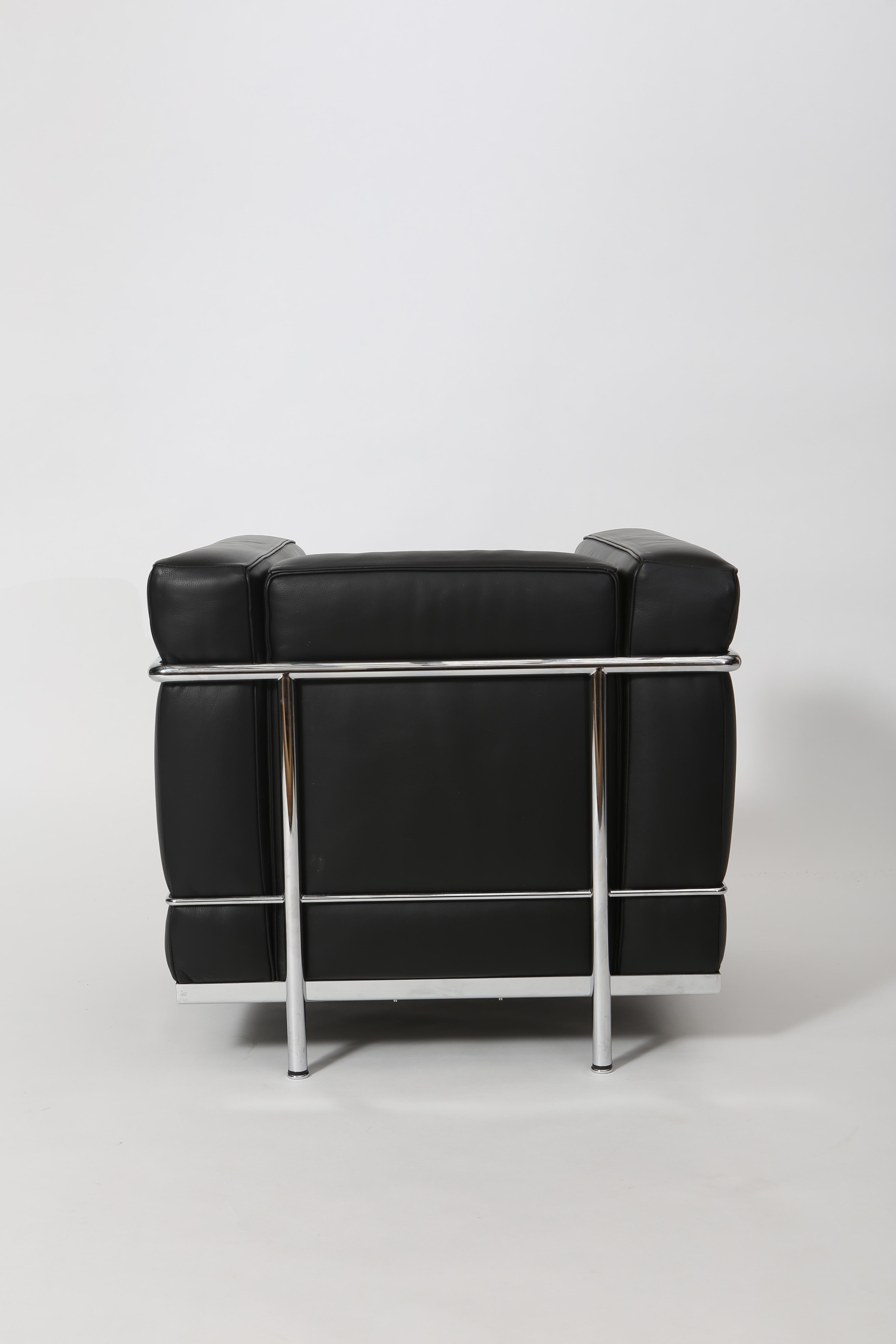 Based on the designs of Le Corbusier, Cassina created the LC 2 line. A petite club chair built for smaller spaces. Full grain leather and chromed steel frame. In excellent condition. Made in Italy, circa 2000.