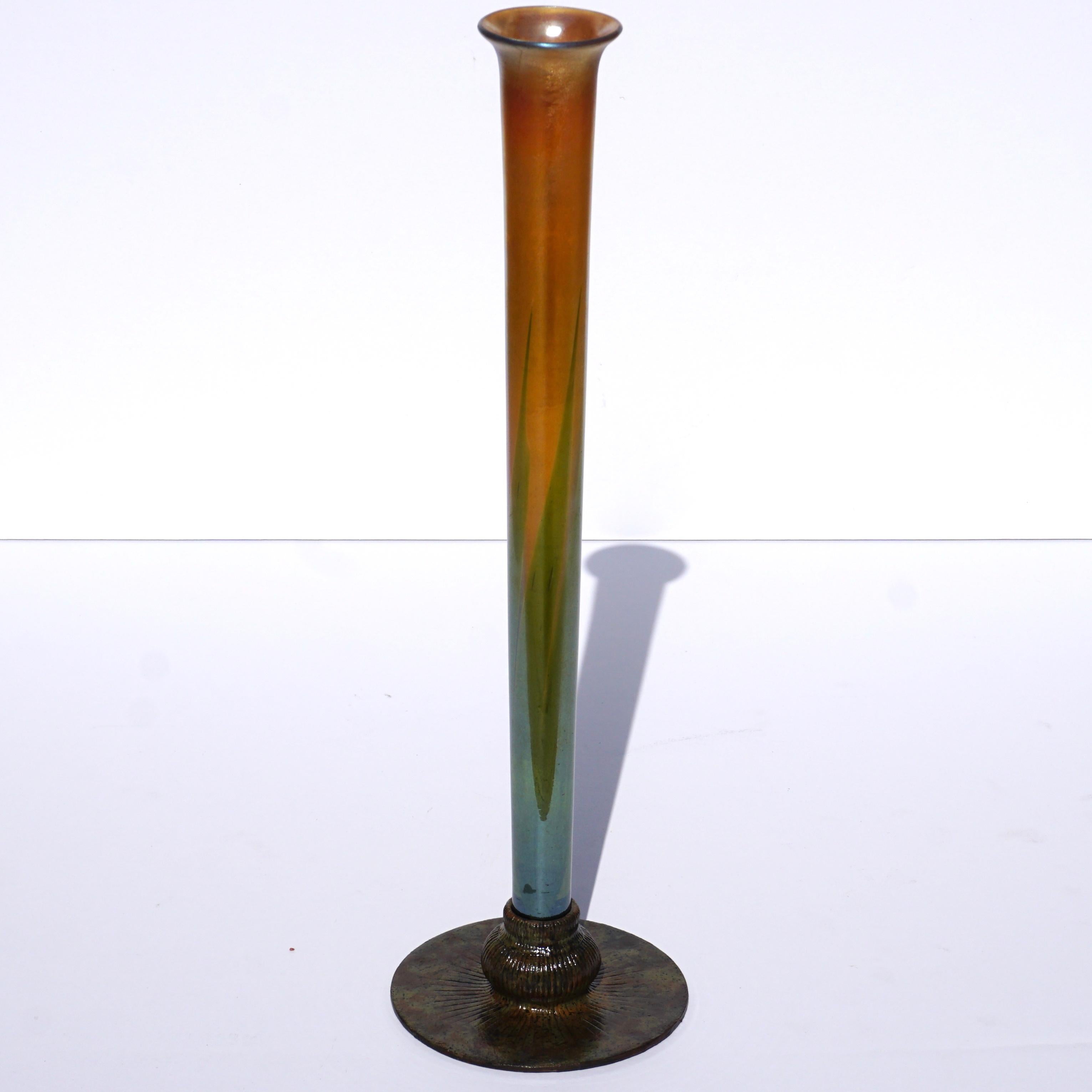 The iridescent gold and pulled green grass strands on this favrile is absolutely stunning (Signed “L.C.T.”). The bronze patinated base with brown and green patina signed “Tiffany Studios New York 710” displays the vase beautifully. Make