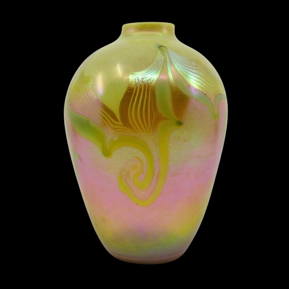 Offering this scare, decorated Louis Comfort Tiffany favrile gold & lime opal art glass footed vase with gold hooked feather decoration. This vase features a bulbous, tapered body with small mouth and thin plain lip. Signed on the underneath 