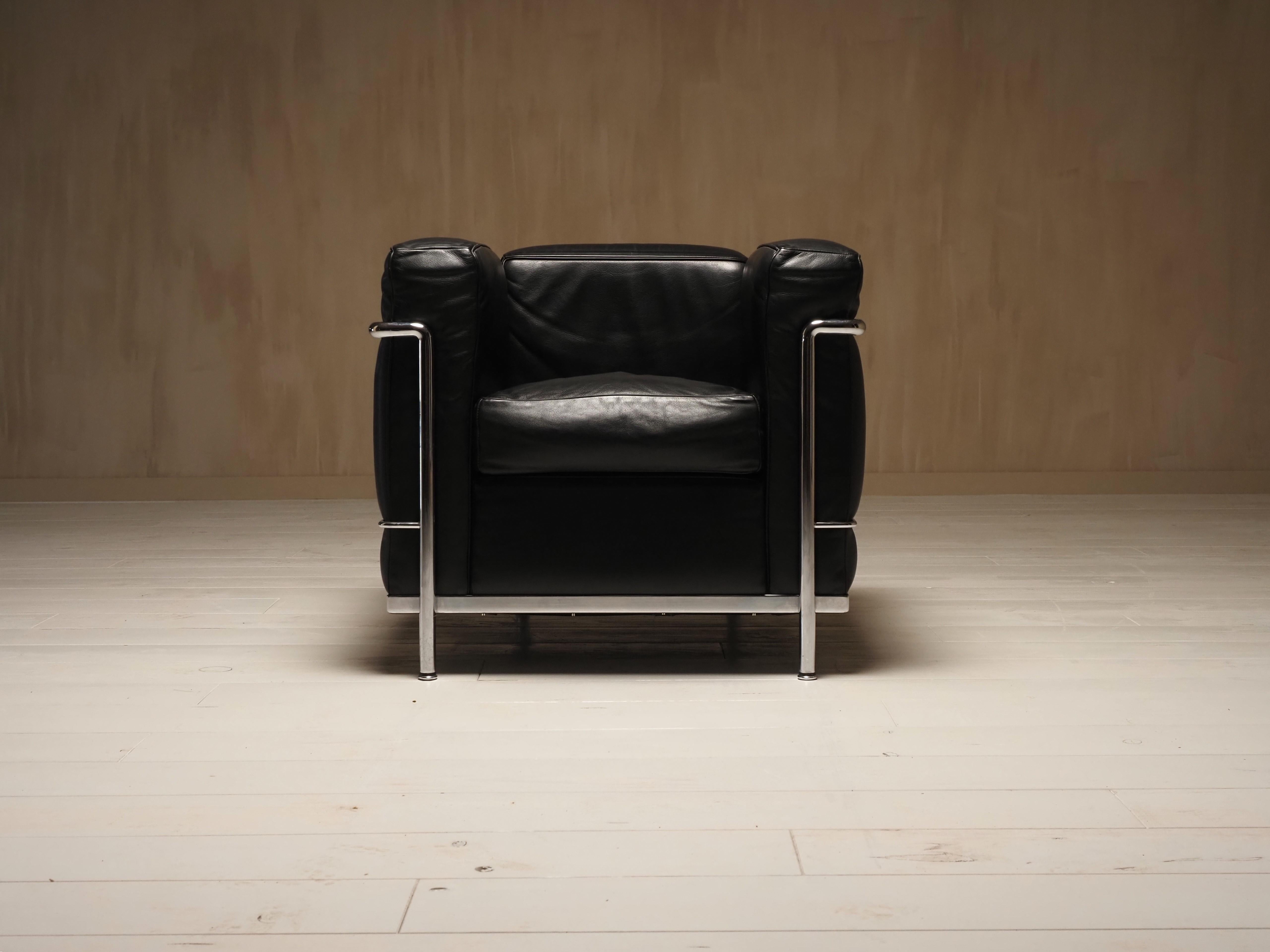 Original LC2 Petit Modele Lounge Chair, initially designed in 1928 by Le Corbusier and his collaborators, Pierre Jeanneret and Charlotte Perriand. This example was produced in Italy in the 1990s by Cassina, and the chair frames are properly engraved
