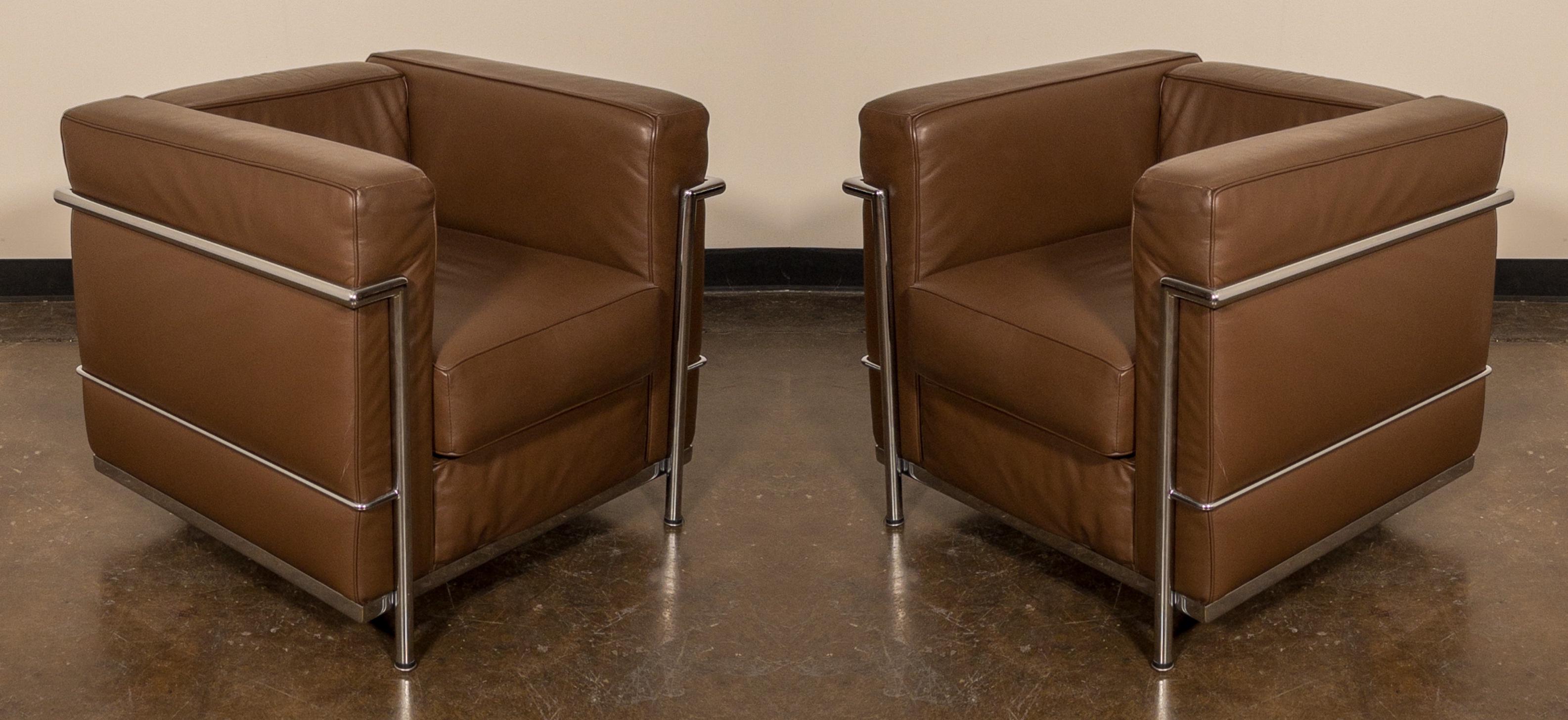 This comfortable set of Le Corbusier for Alivar 'LC2' Club Chairs in gorgeous thick Italian brown leather, signed with Alivar repeat fabric underneath the cushions. Priced per pair in this listing - we have three pairs available (6 chairs in total).