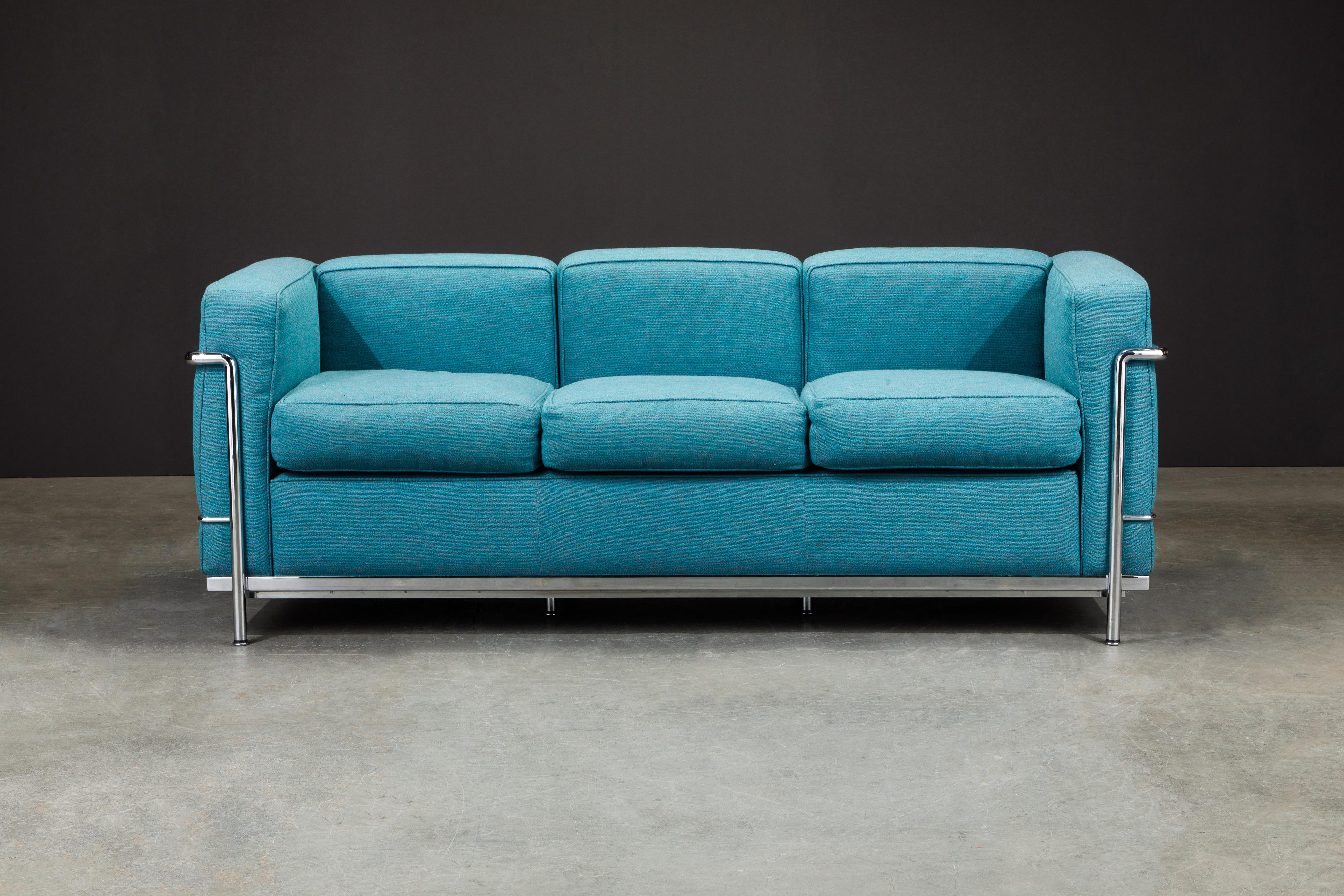 An incredibly comfortable Le Corbusier for Cassina (authentic signed) LC2 three-seat sofa with teal blue fabric cushions and tubular chrome frame. 

The LC2 was designed in 1928 by Le Corbusier; his cousin and colleague Pierre Jeanneret; and