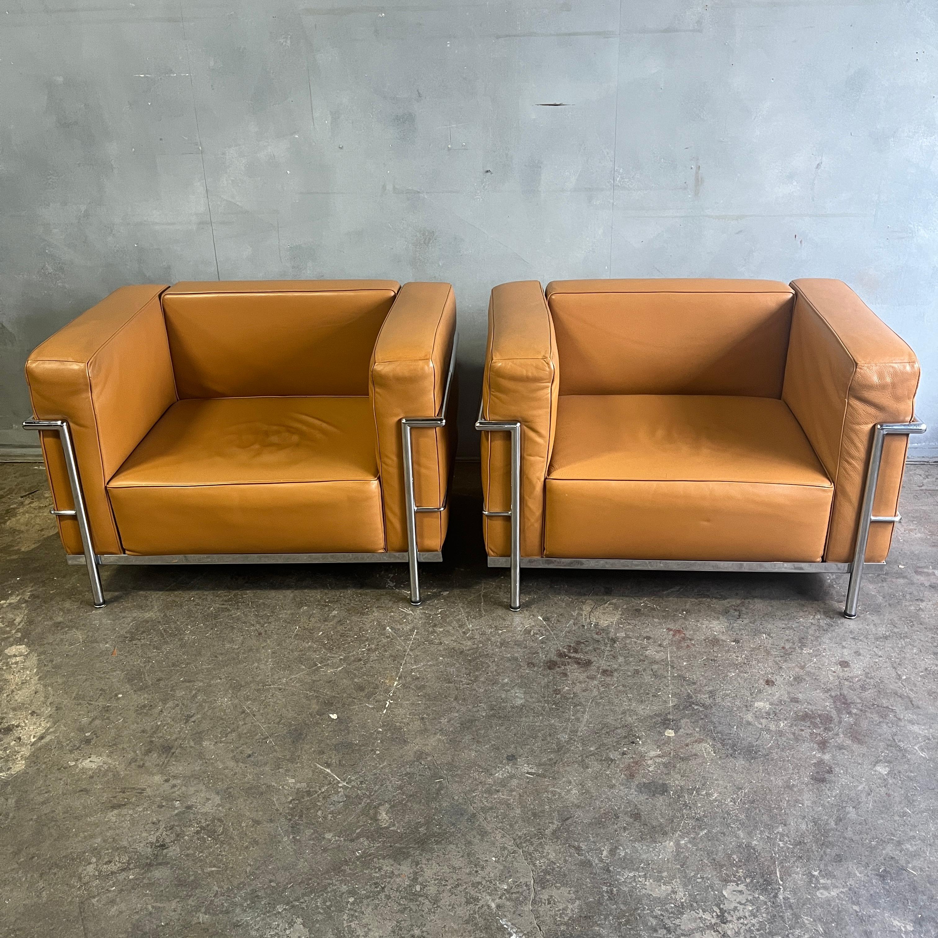 A pair of lounge or club chairs by Le Corbusier, LC3 Grand Confort in Tobacco Leather / saddle brown. Triple chrome plated steel. Gordon International

Labeled.