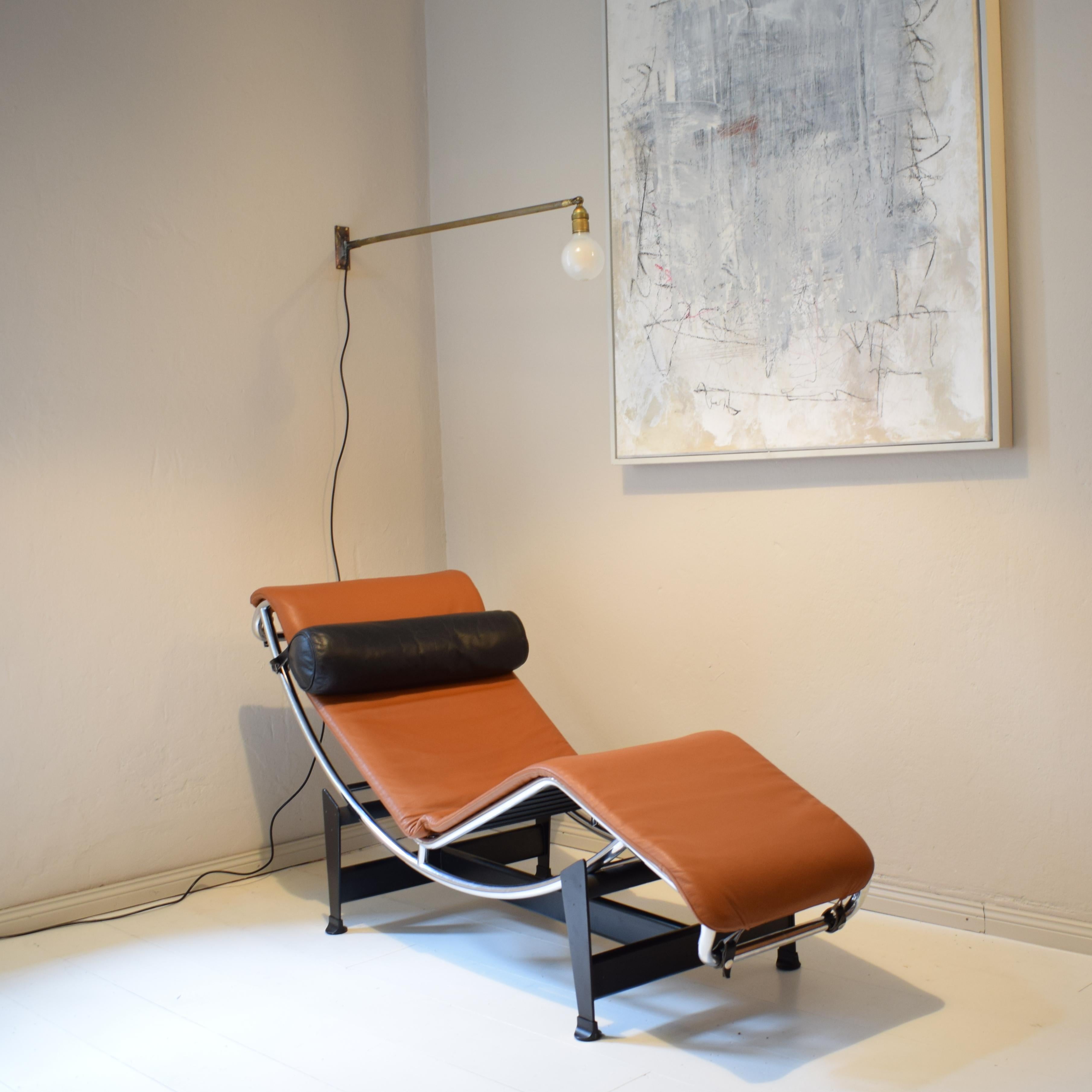 This timeless LC4 chaise Lounge in cognac and black leather by Charlotte Perriand and Le Corbusier was manufactured by Cassina in the 1990.
The cognac leather was redone but the original rose leather case is underneath.

A unique piece which is a