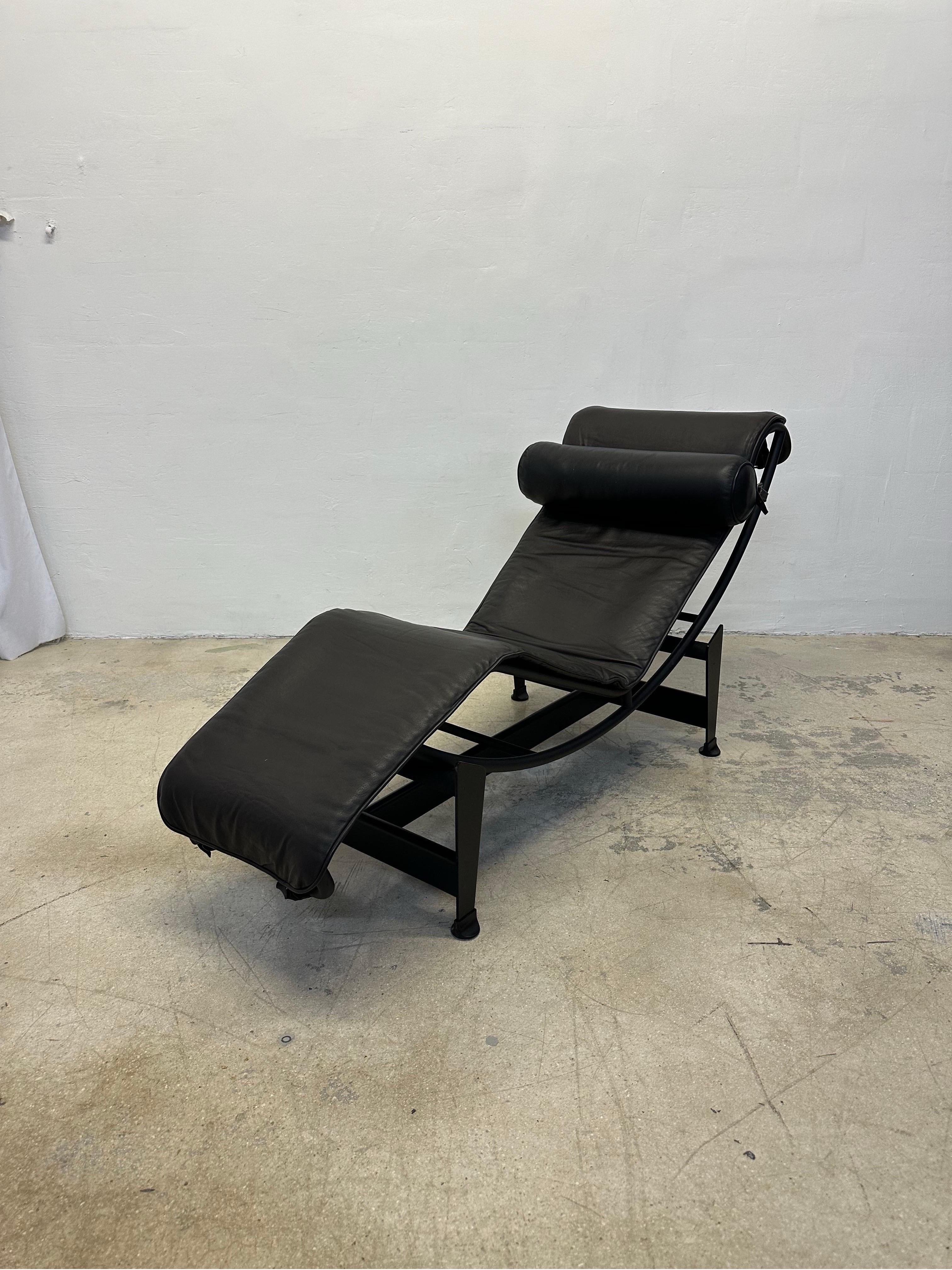 Dark Brown leather LC4 Noire chaise lounge with black leather bolster pillow on black tubular steel and black steel base by Le Corbusier, Pierre Jeanneret and Charlotte Perriand for Cassina. Signed and inscribed on the base and the chaise.

In 1922,