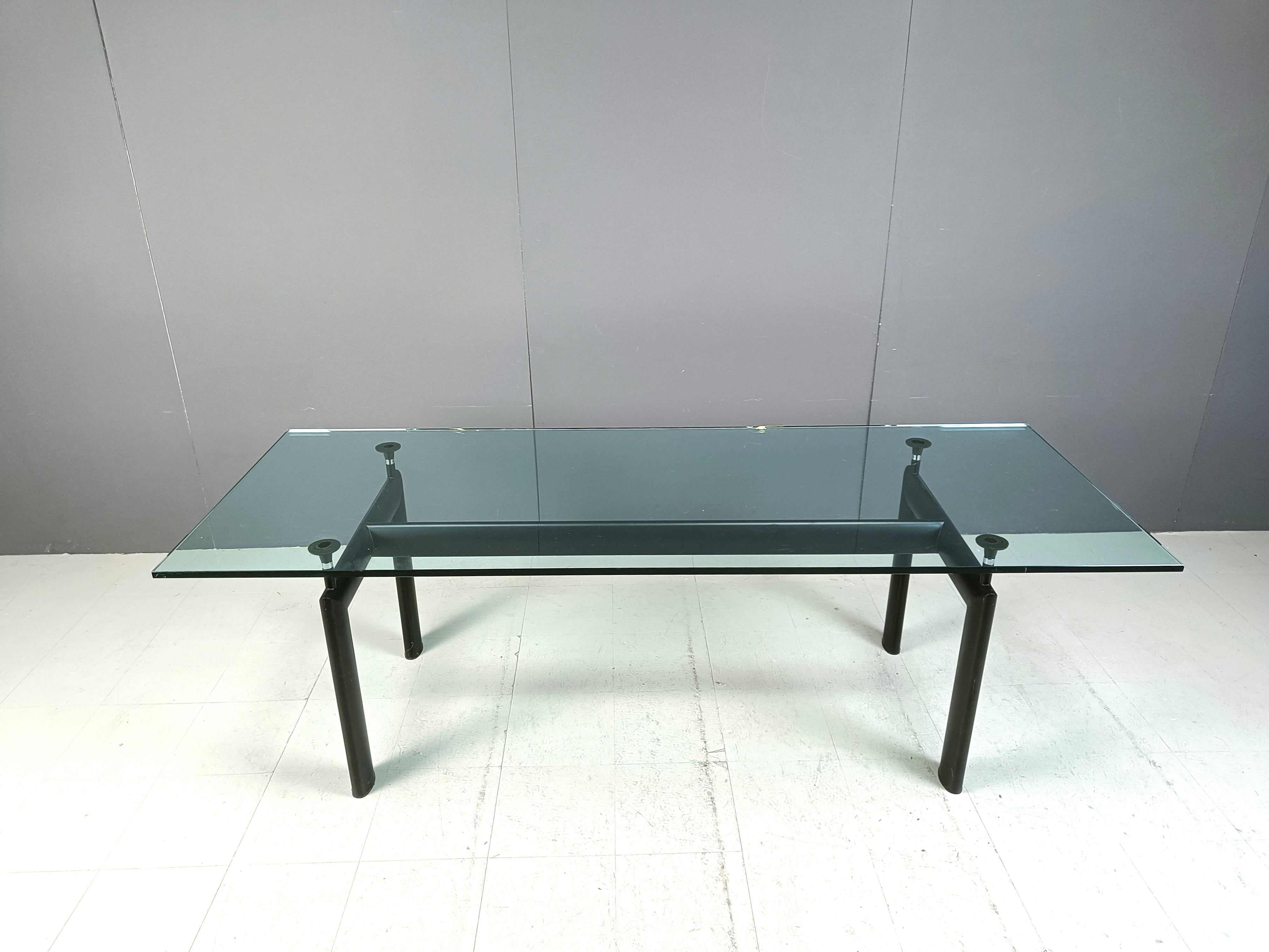 Dining table designed by Le Corbusier, Pierre Jeanneret, Charlotte Perriand originally in 1928 for the Salon d’Automne in Paris and relaunched in 1974 by Cassina.

It features a black aluminum base with 4 adjustable supports which make the table top