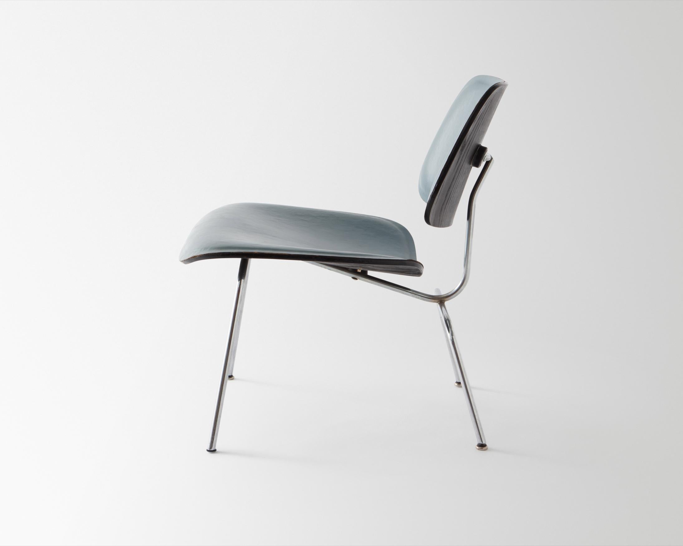 LCM (Lounge Chair Metal). Designed 1946. Manufactured by Herman Miller, Zeeland, Michigan, circa 1951-1956. Molded ash plywood with original black aniline dye finish and original blue leather upholstery, chrome-plated steel, rubber shock mounts