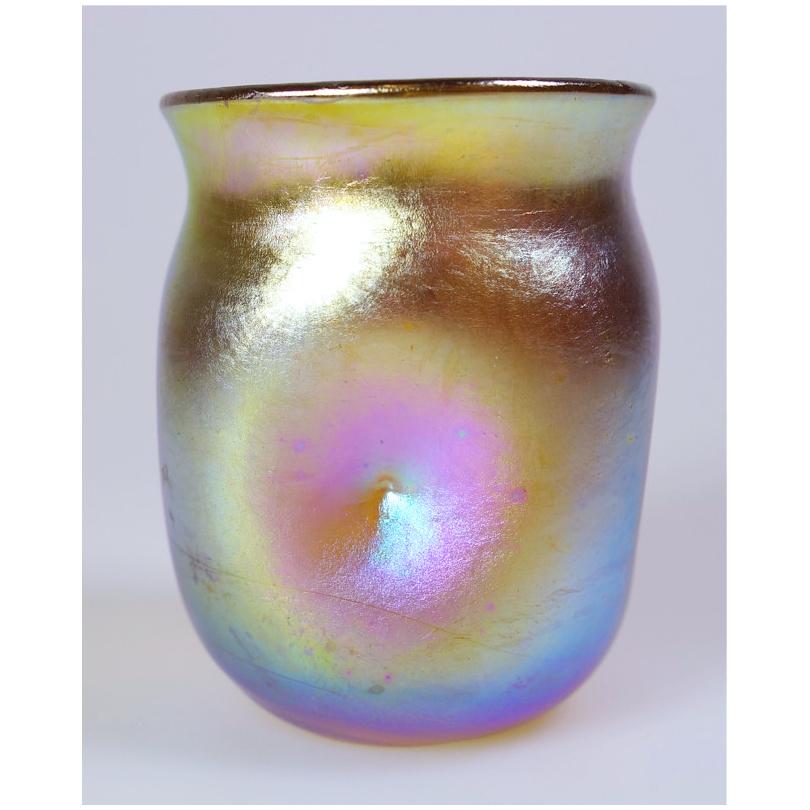Offering this diminutive Louis Comfort Tiffany gold Favrile iridescent art glass cordial glass that may also be used as a toothpick holder / shot glass. This cordial features a square rounded body with 