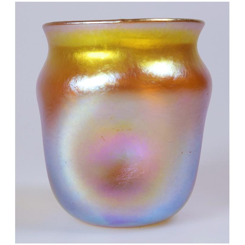 Offering this diminutive Louis Comfort Tiffany gold Favrile iridescent art glass cordial glass that may also be used as a toothpick holder / shot glass. This cordial features a square rounded body with 
