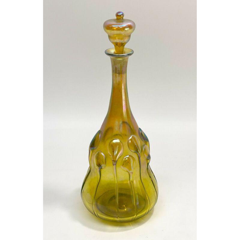 LCT Tiffany favrile gold iridescent lily pad decanter applied tendrlls, circa 1890.

Applied lily pads tendrils throughout the double gourd shaped body. Tiffany Studios mark to the underside base - signed LCT above the etched numbers. With