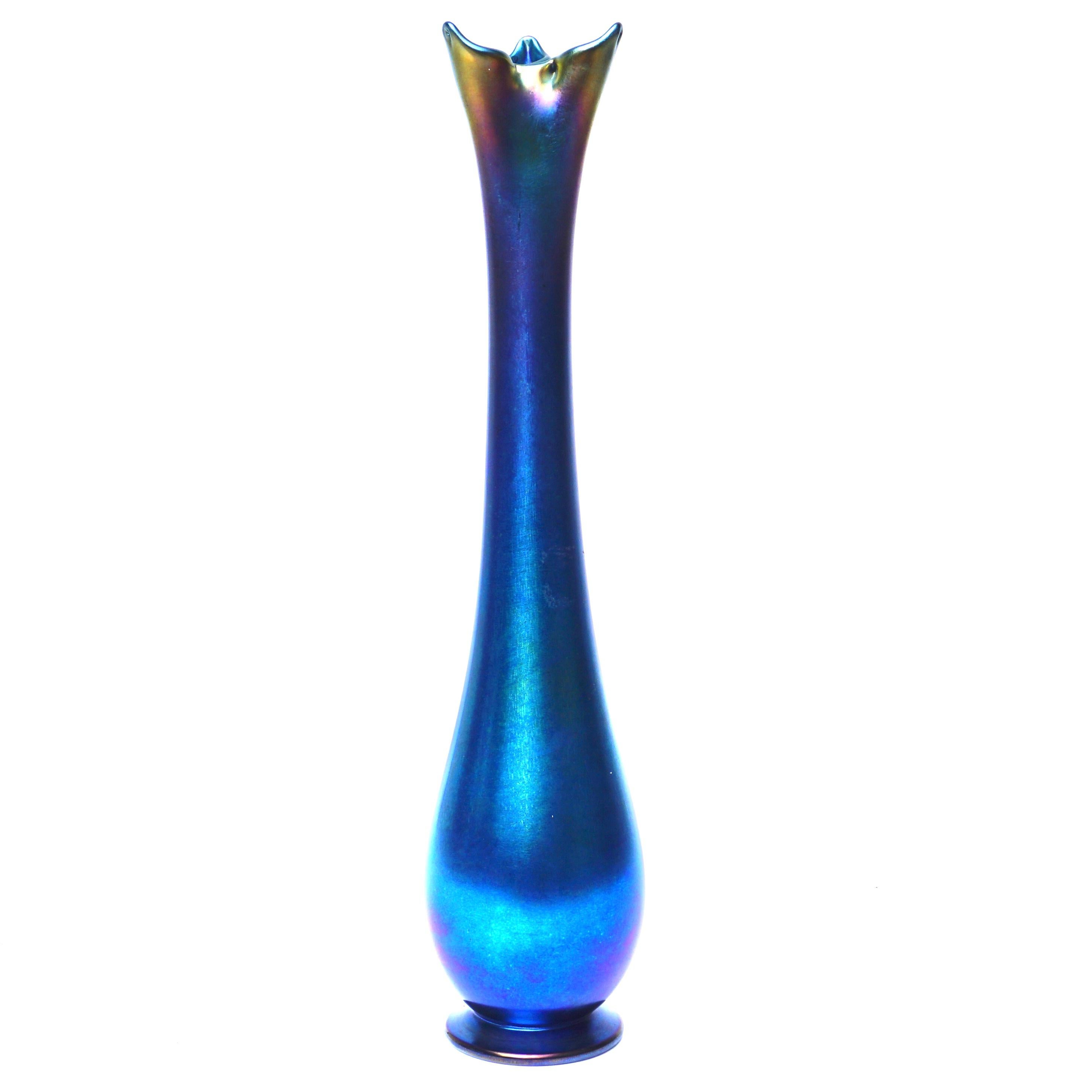 LCT Favrile Vase. Tiffany studios, New York, #5935D. 

Description: WOW! More beautiful than the photos if you can believe it. Tiffany made one blue vase to every 75 gold Favrile pieces. Rare and beautiful. Amazing deep iridescence of many blues,