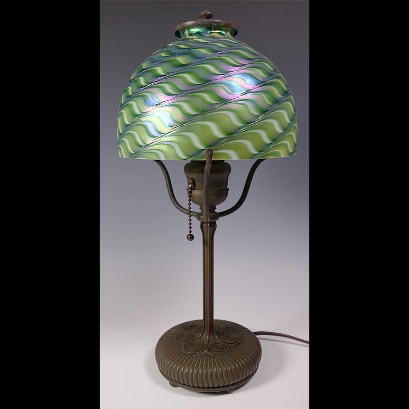 Presenting this rare Tiffany Studios “boudoir” or desk lamp made from bronze and features a feathered 