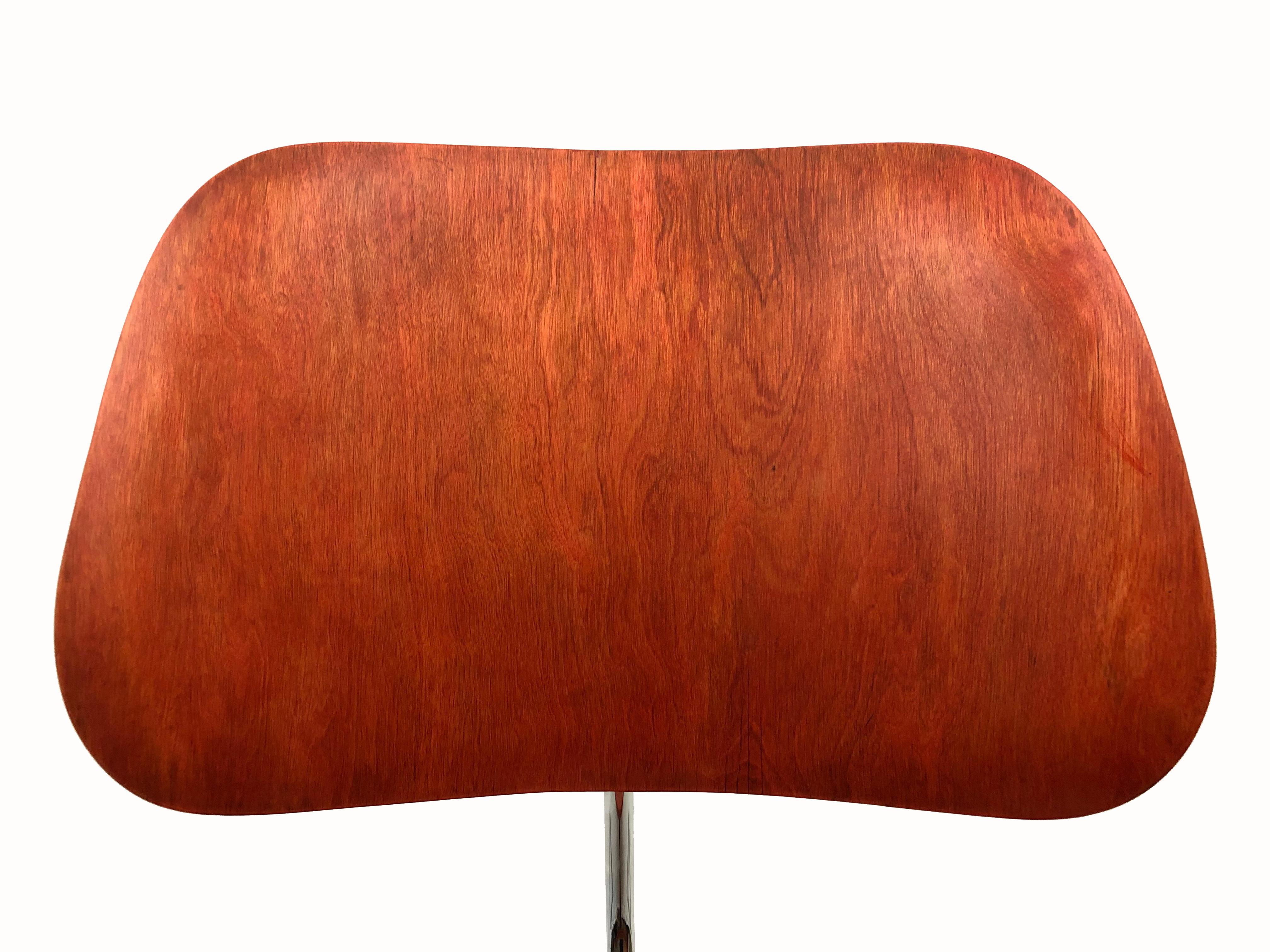 An early edition LCM lounge chair by Charles and Ray Eames for Herman Miller in the Eames' proprietary aniline red finish.