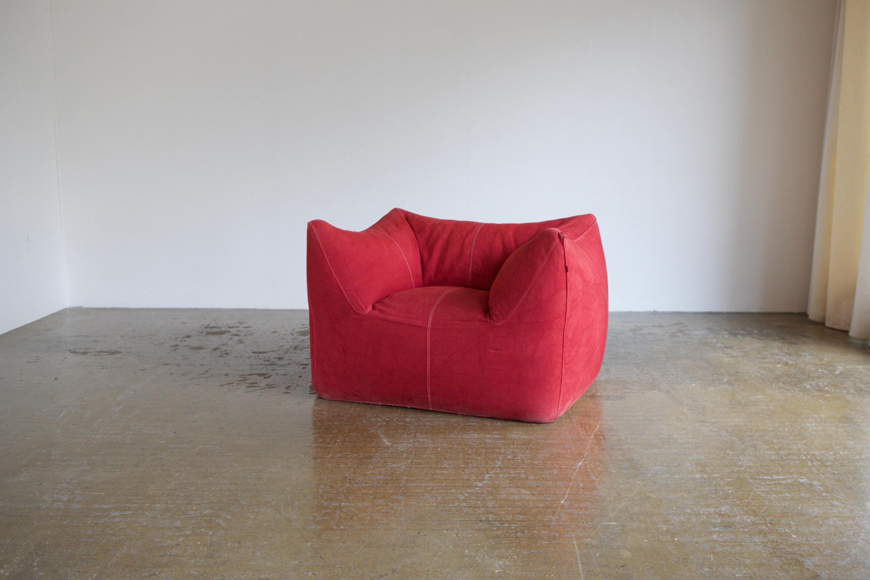 A 1970's classic, Le Bambole by Mario Bellini for B&B Italia. This is the full chair version with arms and is covered in it's original red twill canvas. The chair is solid and sturdy and extremely comfortable. The only condition issue is a small