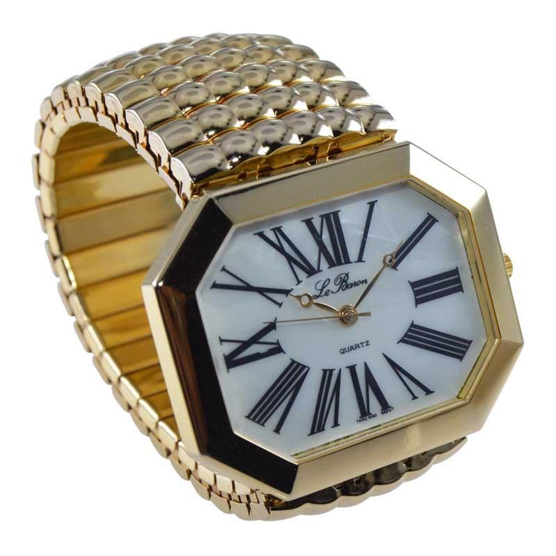 FACTORY / HOUSE: Le Baron Watch Company
STYLE / REFERENCE: Moderne Oversized
METAL / MATERIAL: Gold Plated
CIRCA / YEAR: 1980's
DIMENSIONS / SIZE: Length 52mm x Width 41mm 
MOVEMENT / CALIBER: Quartz
DIAL / HANDS: Original Opalescent with Original