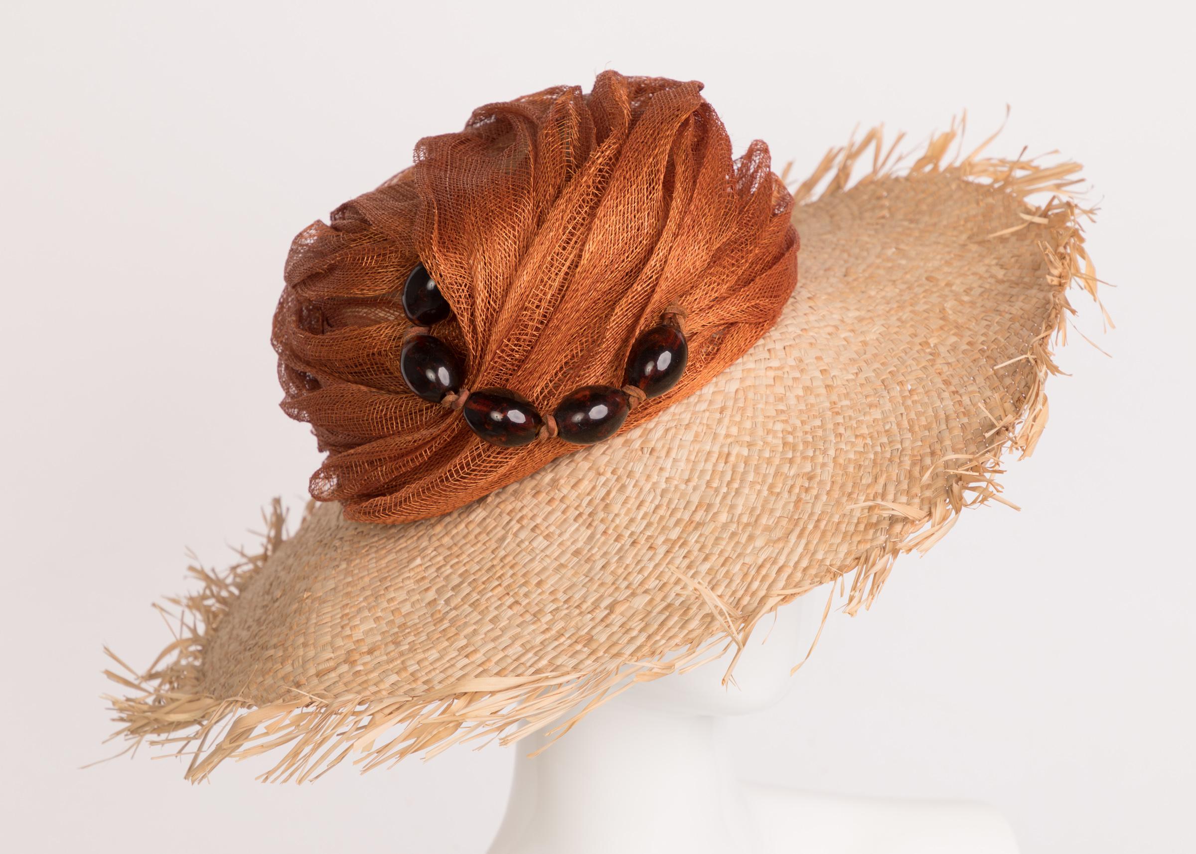 Light and refreshing, a well-coordinated accessory is the finishing touches to any great look. Made from a light tan raffia, this hat wonderfully merges a variety of textures with a well-balance monochromatic harmony. The crown of the hat is wrapped