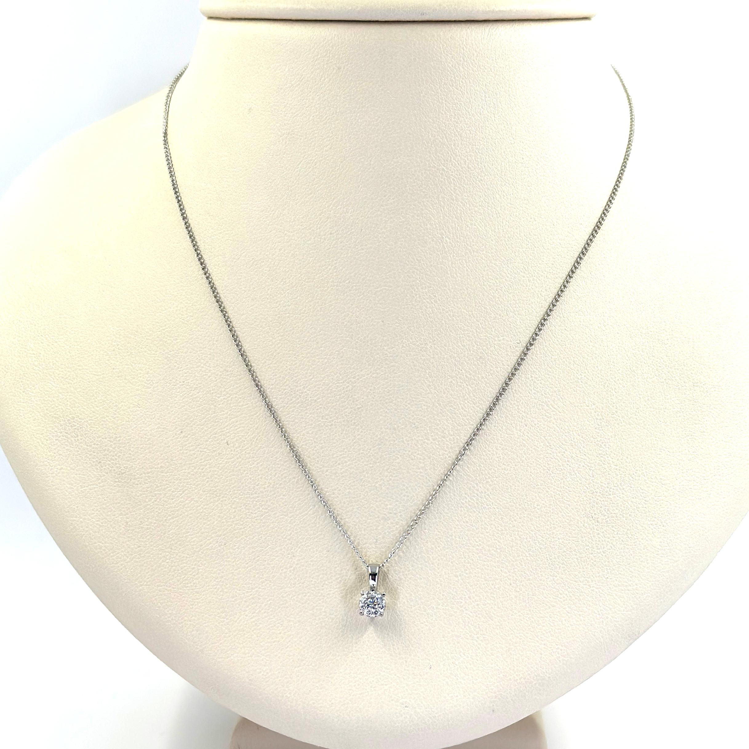 Le Cirque 14 Karat White Gold Diamond Cluster Pendant Necklace Featuring 9 Round Diamonds of VS Clarity and G Color Totaling Approximately 0.10 Carats. Open Curb Link Chain Measuring 15 Inches Long. Finished Weight is 1.3 Grams. 