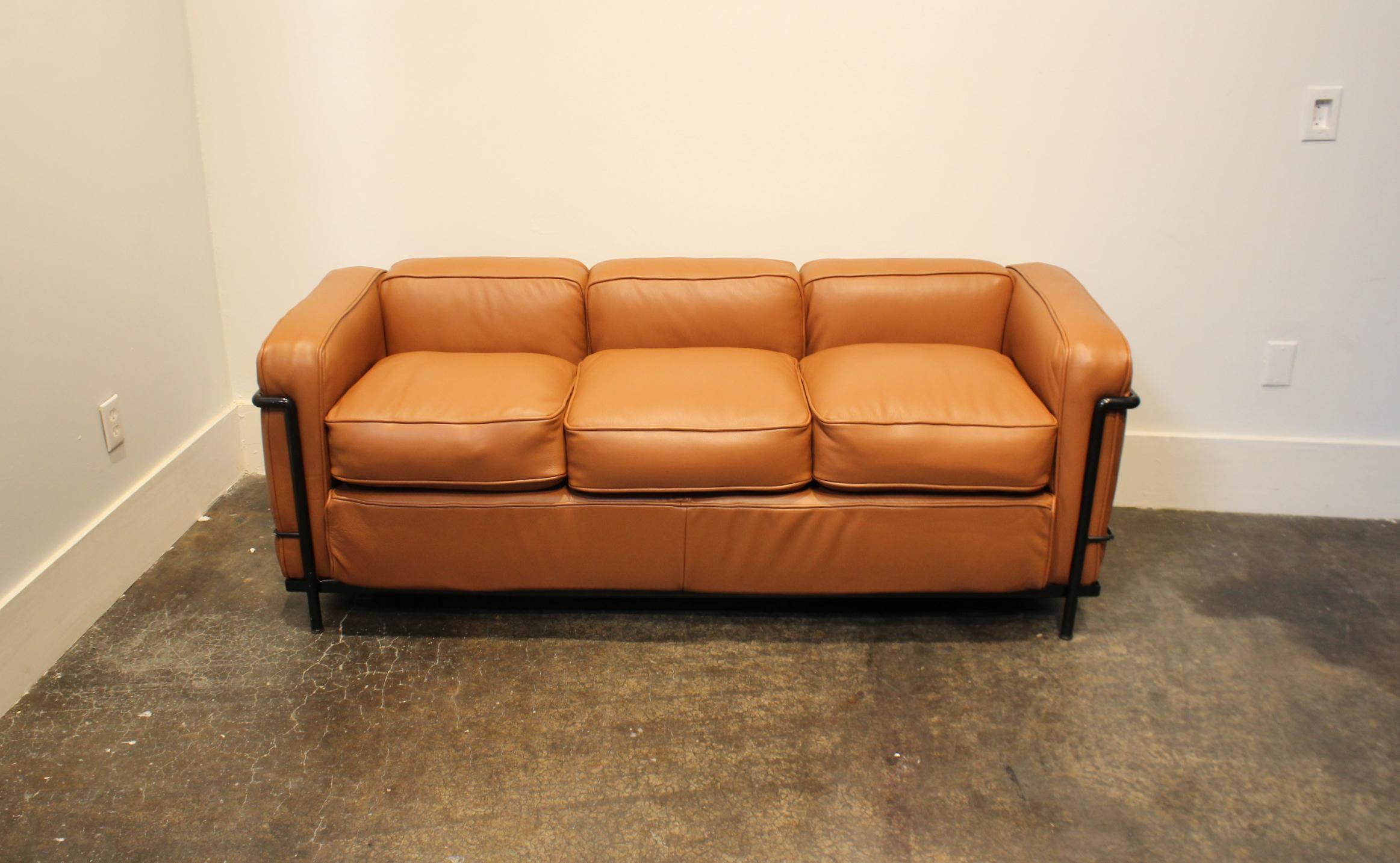 Black, enameled-steel, tubular frame with thick, newly upholstered caramel/brown leather. Made in Italy by Cassina during the 1970s-1980s. Cassina stamp on inside of steel frame. Very light wear to frame, brand new leather.