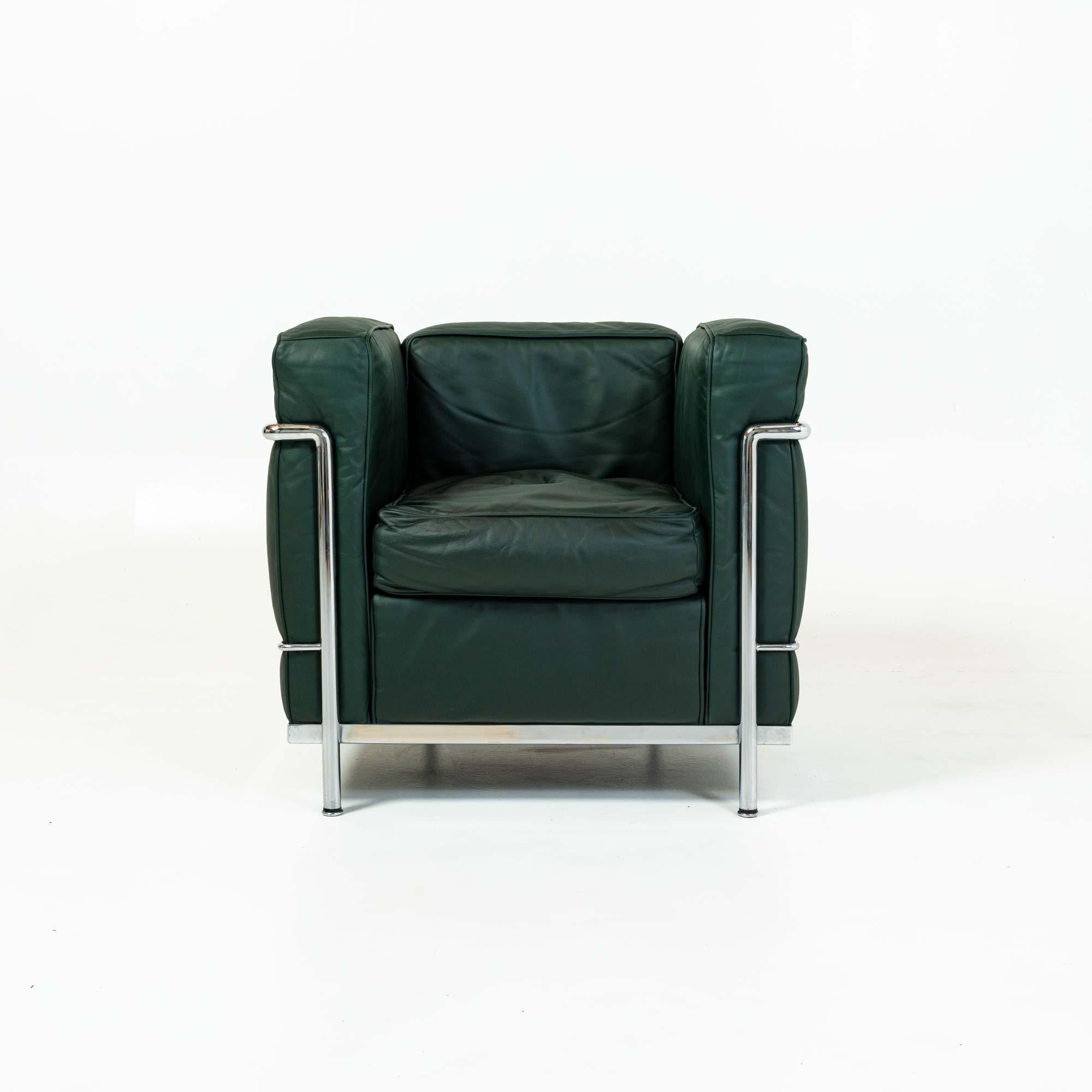 A good condition LC2 Petite Modele Armchair Designed by Le Corbusier, Pierre Jeanneret, Charlotte Perriand, produced by Cassina, in original midnight green leather cushions and chrome frame. Stamped on the frames with Cassina model number and