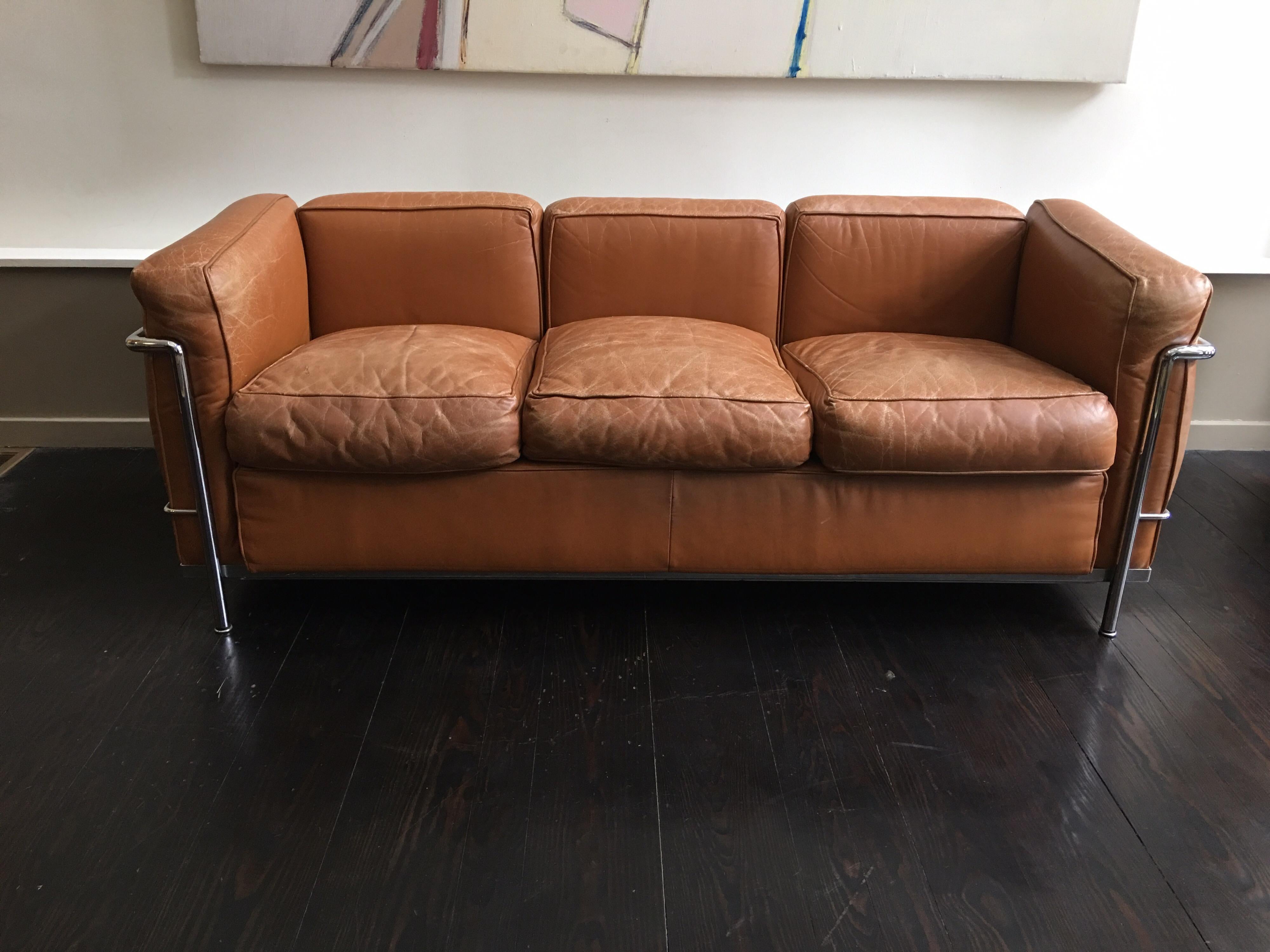 Le Corbusier for Cassina LC2 three-seat sofa. 2 available! These were purchased by architects for their home in 1972 Tan leather with chrome frame. Perfect amount of patina to the leather cushions! Retains Cassina labels.