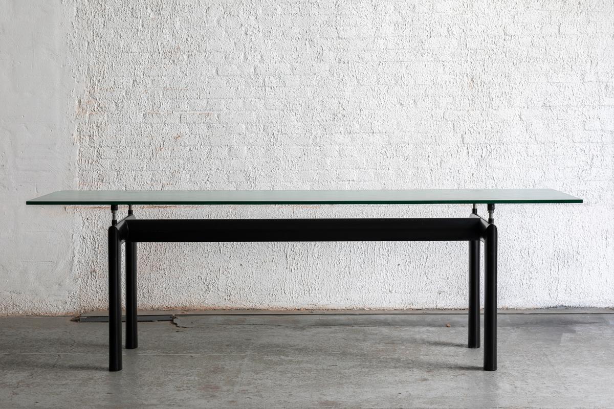 Large dining table LC6 designed by Le Corbusier and produced by Cassina in Italy in the 1980s. This table features a black lacquered metal base with a top in blurred glass. A streamlined design, true to the Modernist spirit of his architectural