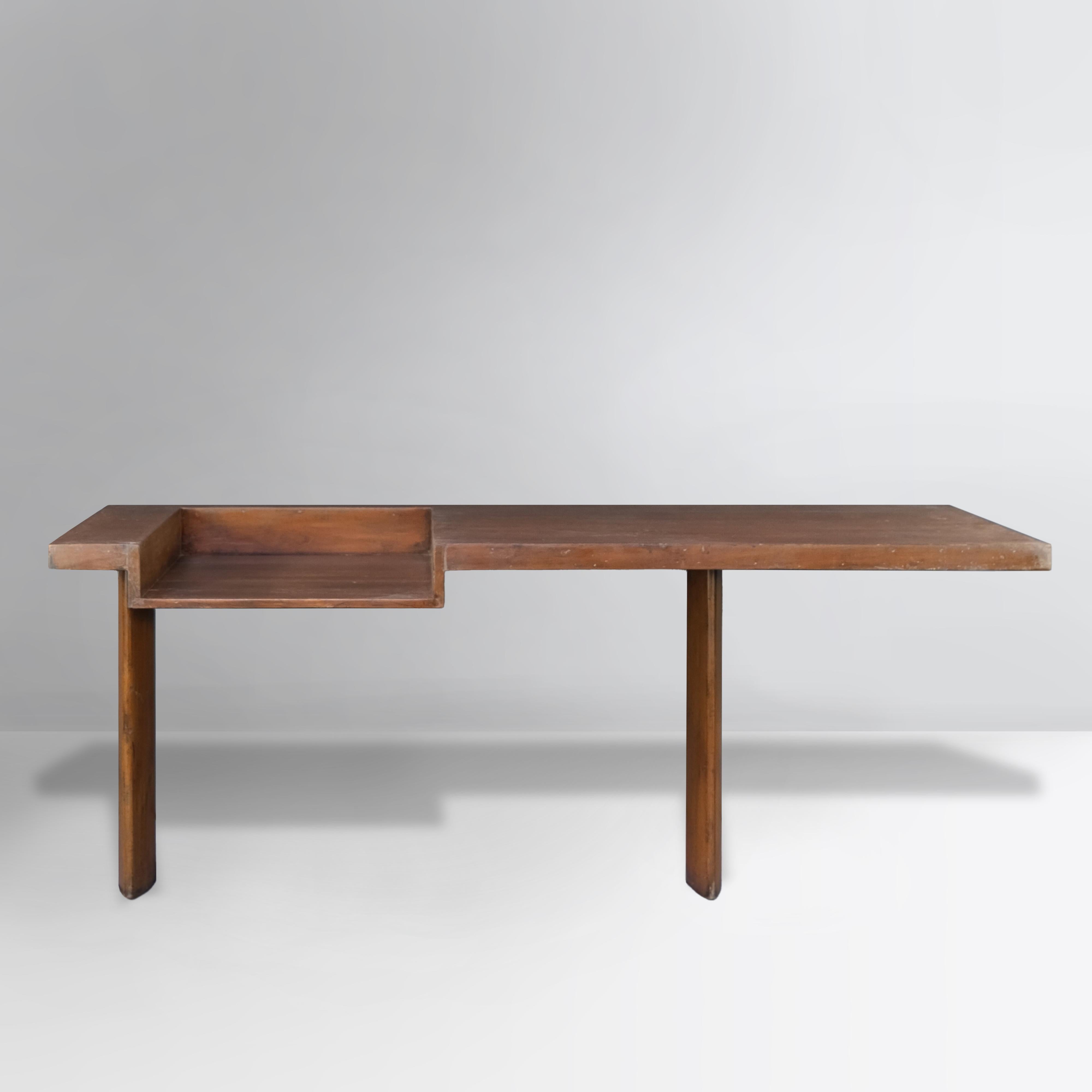 This console desk was created by B. Doshi and Le Corbusier. It is not only a very rare piece but also an item of museum quality. It is raw in its simplicity and splendid with that solid teak wood, which shows a strongly patinated material. We didn't
