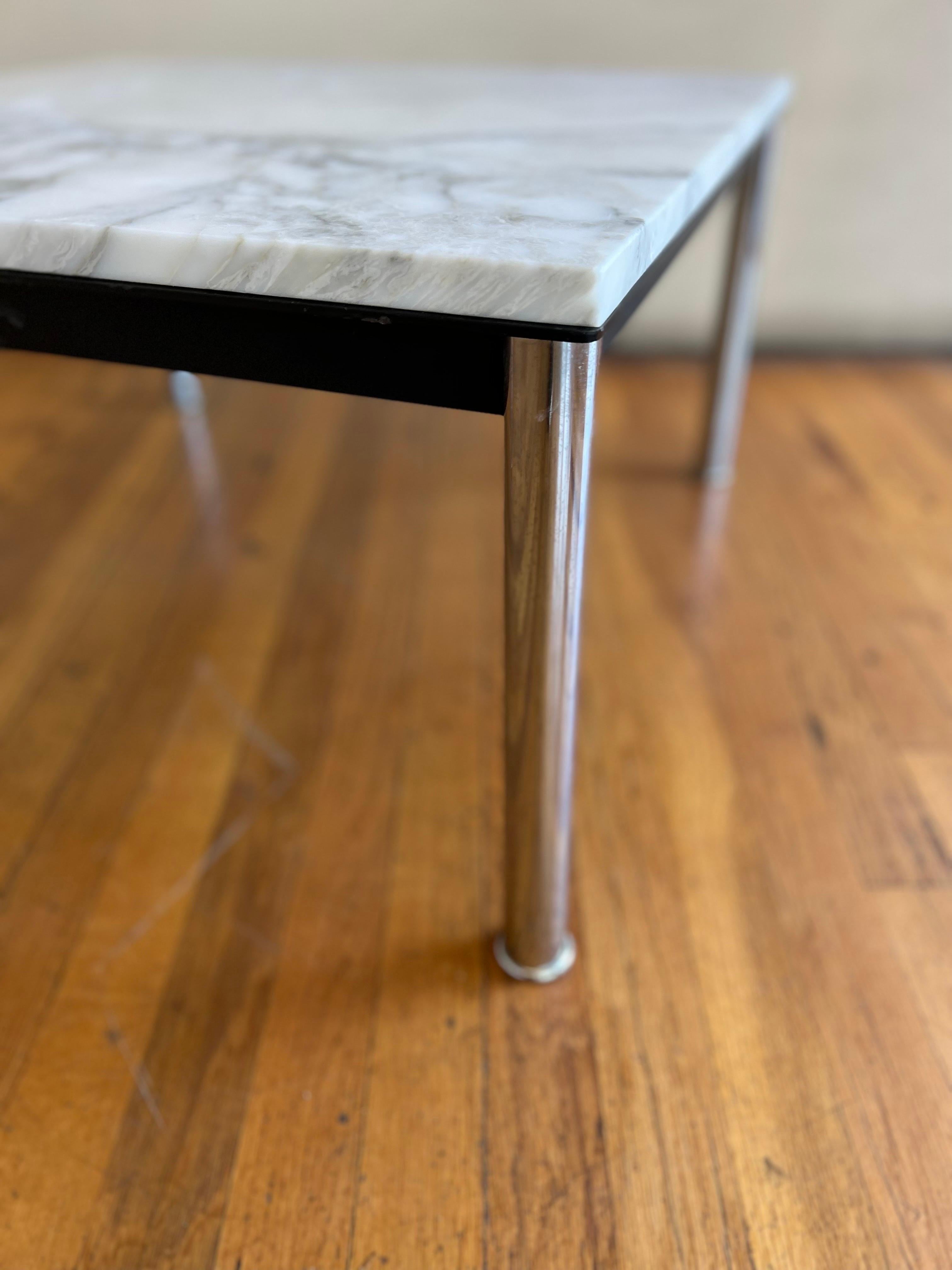 Great simple elegant design on this small coffee cocktail end table designed by Le Corbusier, circa the 1970s Made in Italy with custom made Italian Carrera Marble Top, chrome polished legs with solid steel black enameled edge nice solid and sturdy.